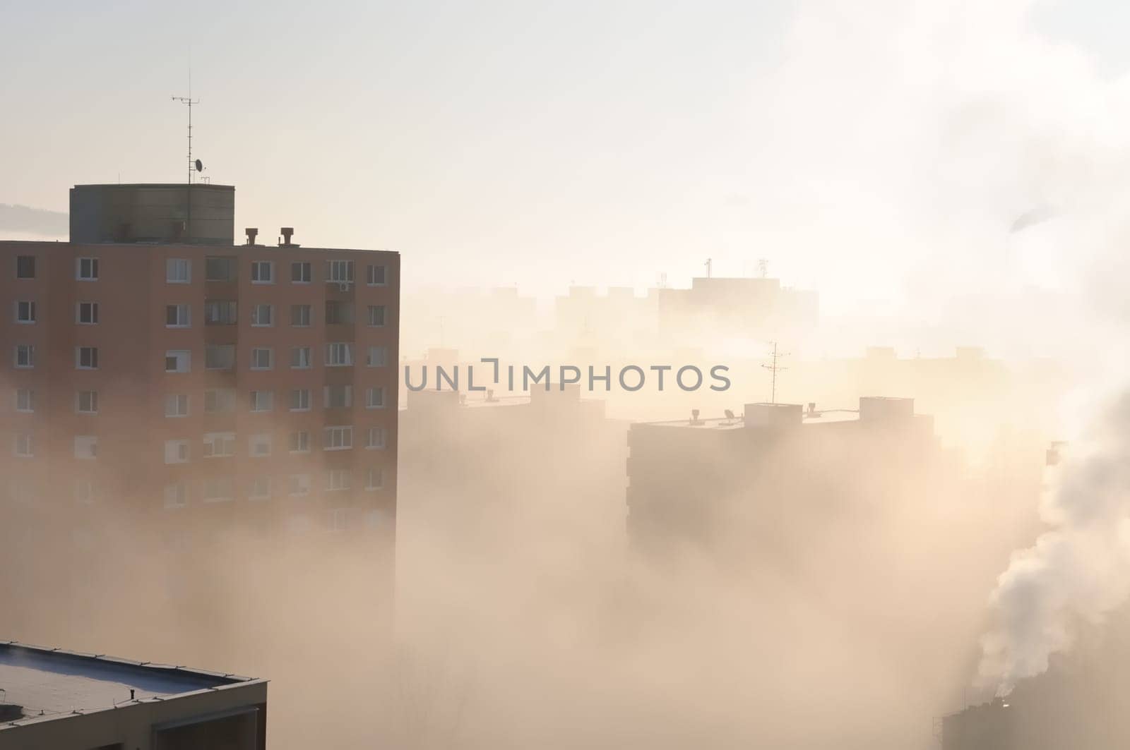 Residential area in fog and smog with chimney in background