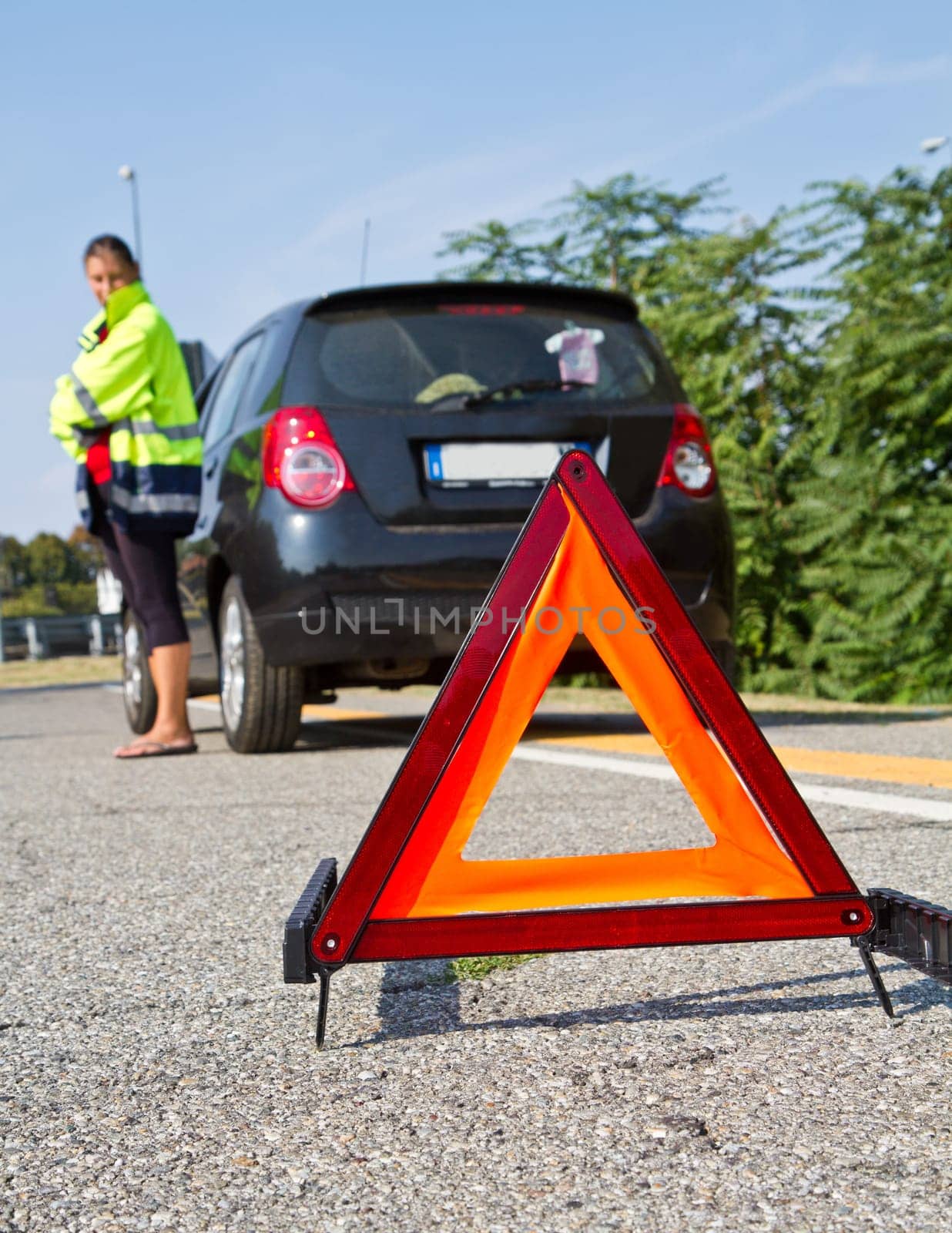 Broken down car with red warning triangle