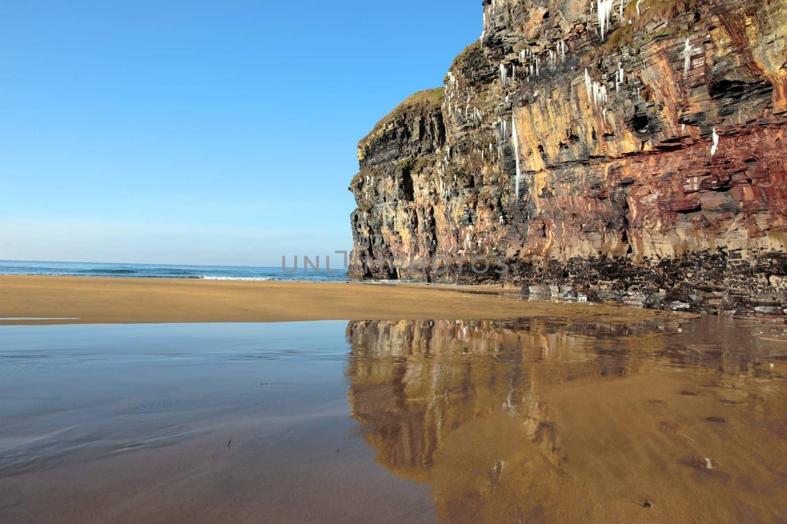 icicles on a cliff face on ballybunion beach in ireland on a winters morning