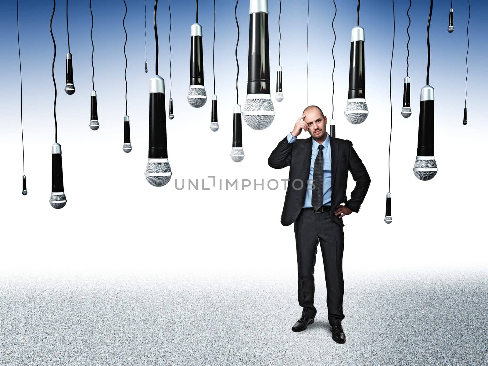 standing businessman and lots of microphone