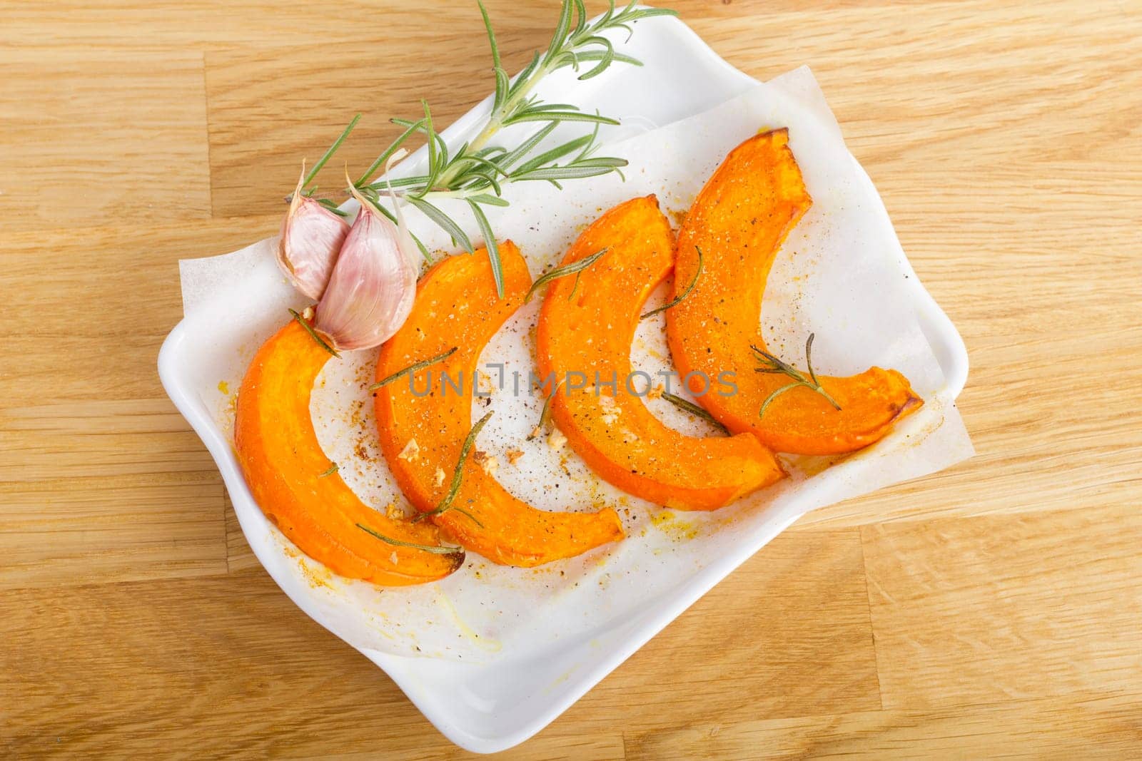 Baked pumpkin wedges with rosemary and garlic