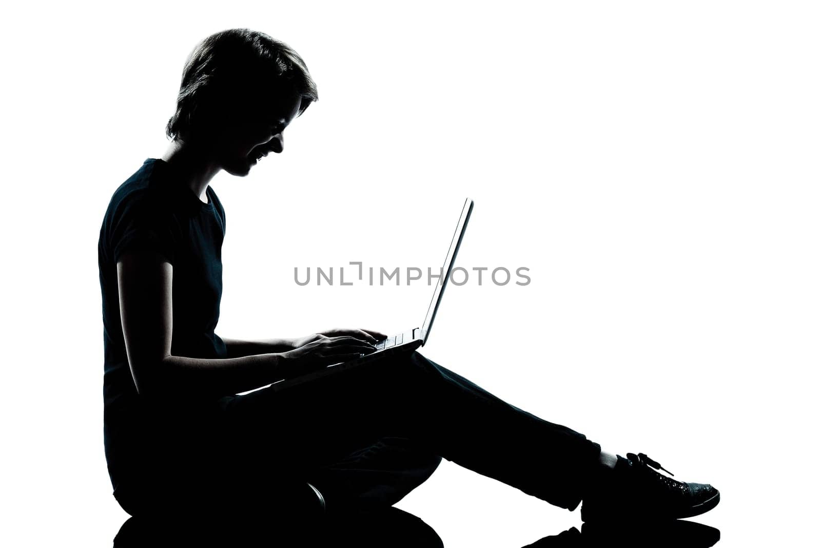 one caucasian young teenager silhouette boy girl computer computing laptop smiling full length in studio cut out isolated on white background