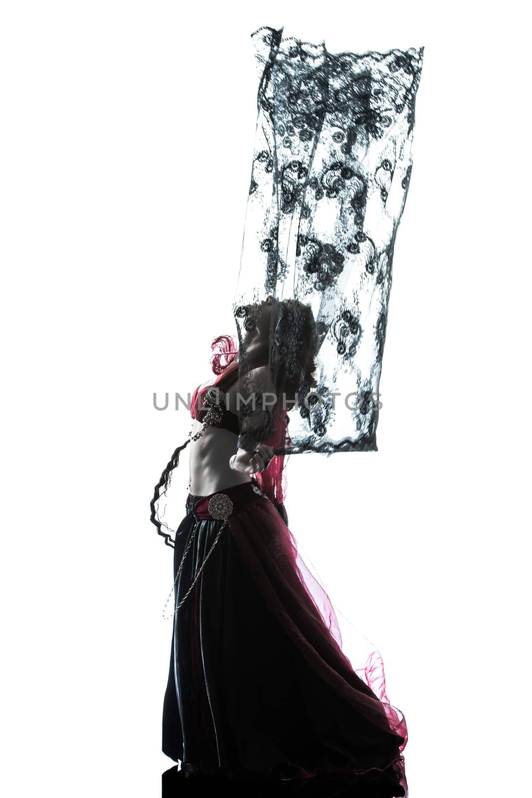 one arabic woman belly dancer dancing silhouette studio isolated on white background