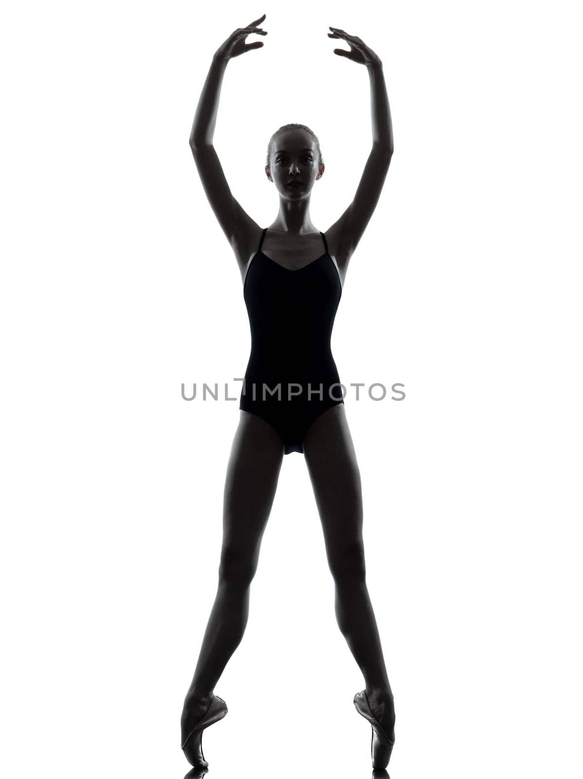 one caucasian young woman ballerina ballet dancer stretching warming up in silhouette studio on white background