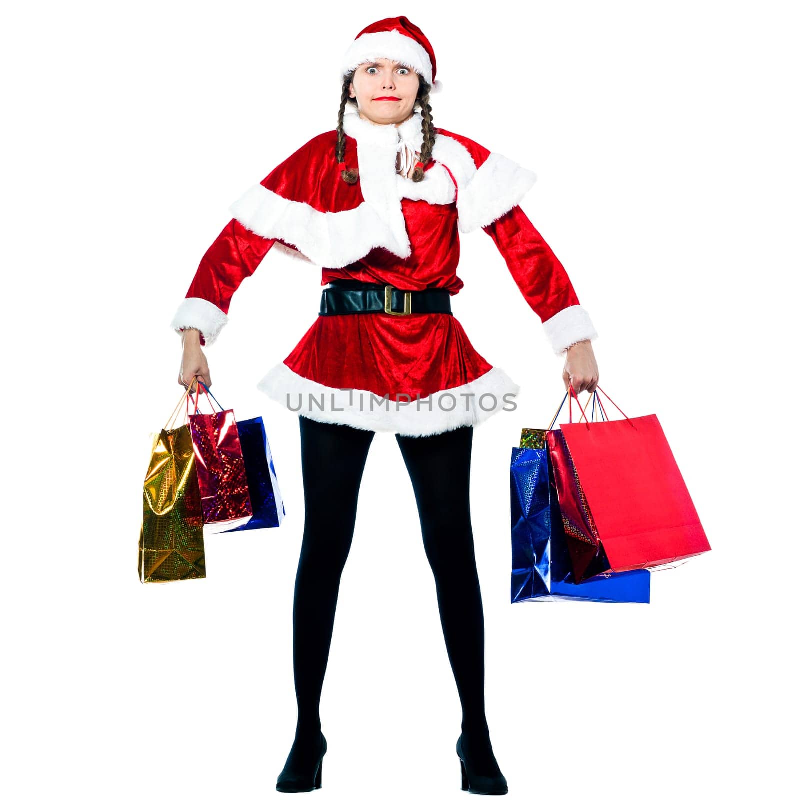 one strong woman dressed as santa claus carrying christmas bags  on studio isolated white background