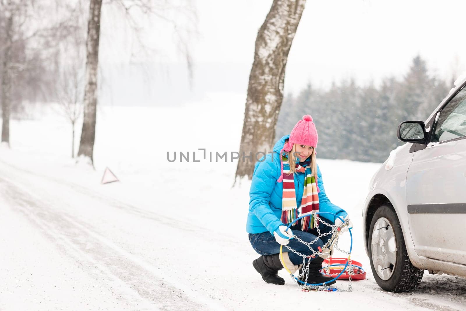Snow tire chains winter car woman in trouble breakdown