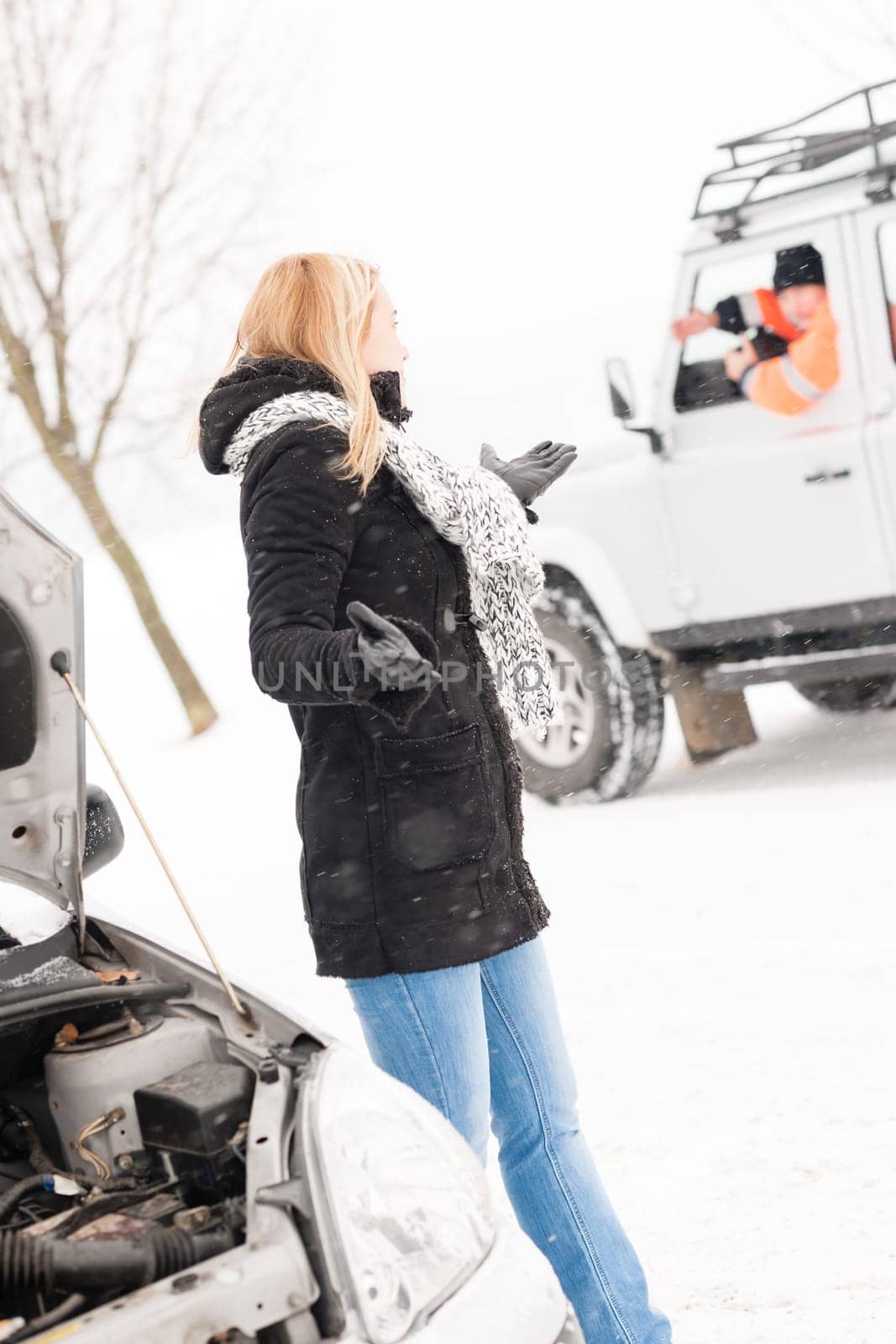 Woman having trouble with car snow assistance winter talking man