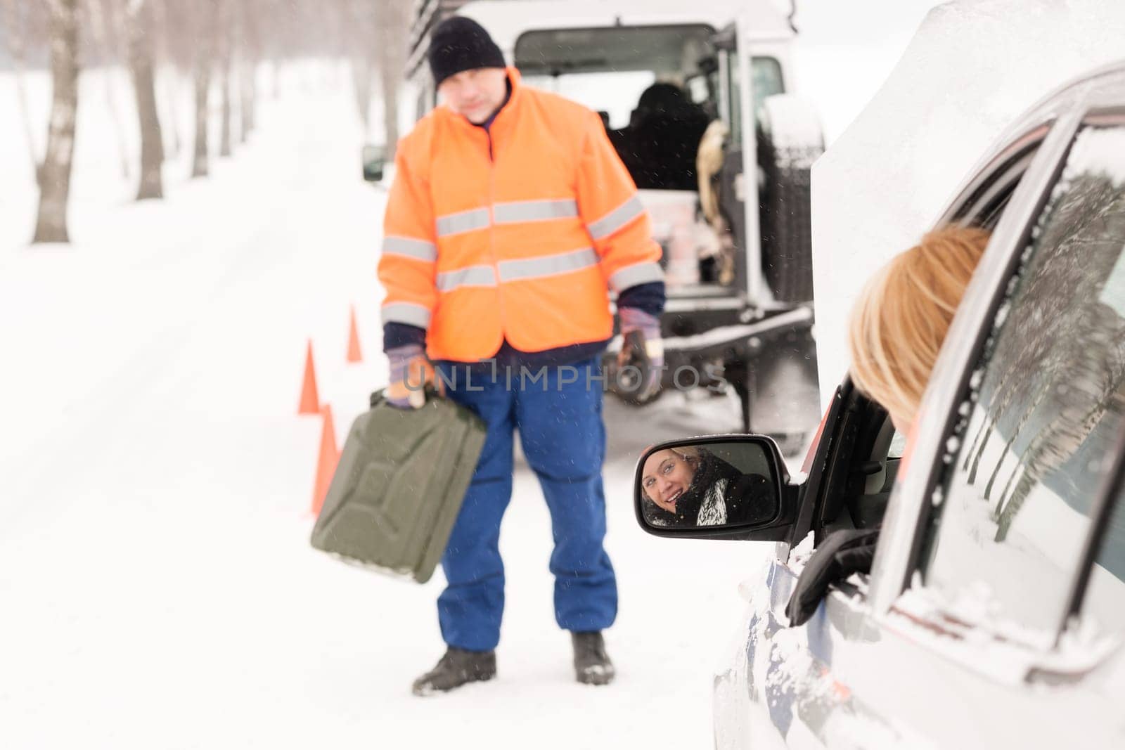 Woman broken car man gas can snow assistance winter mechanic