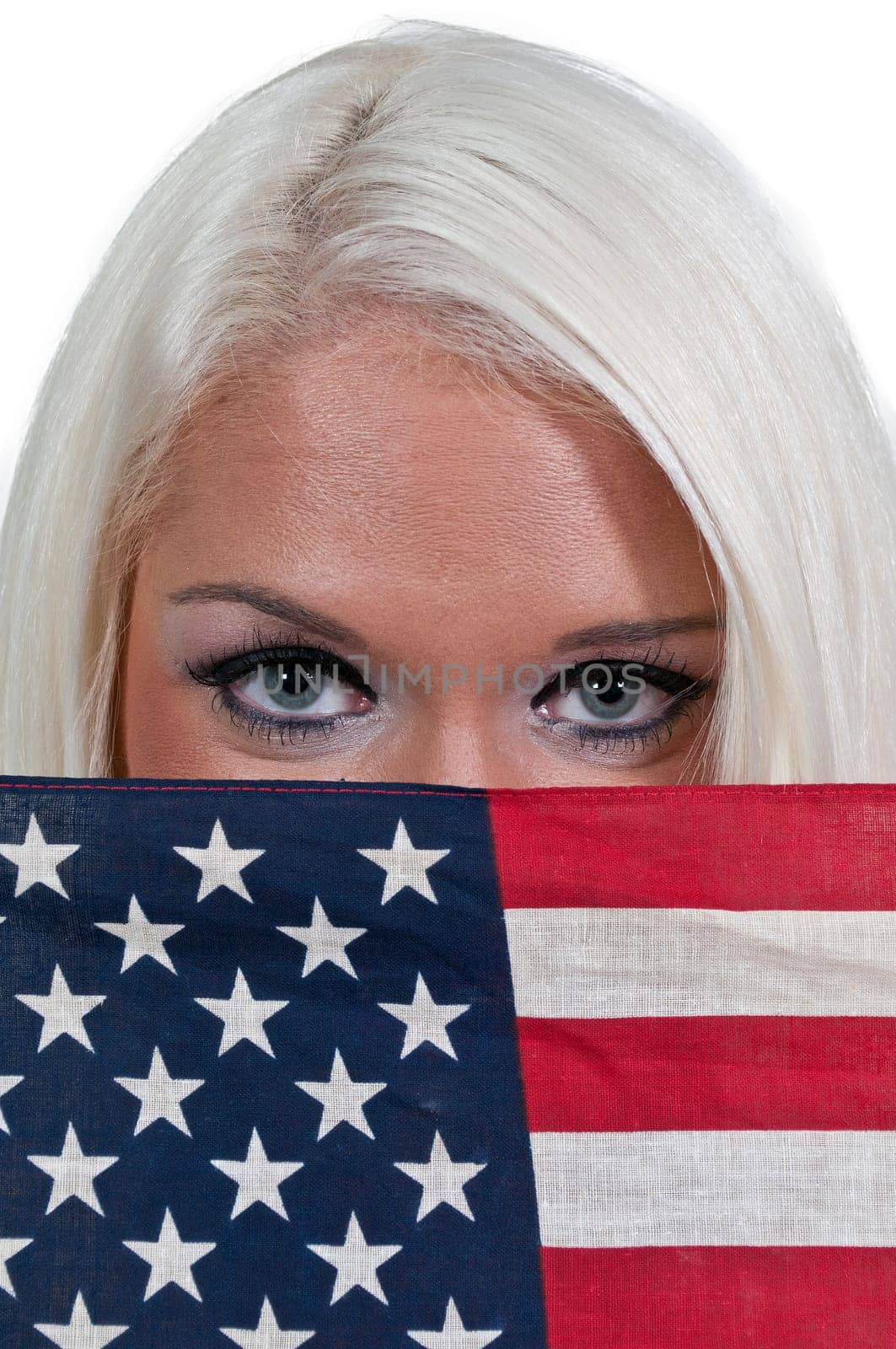 A beautiful young woman holding an American flag.