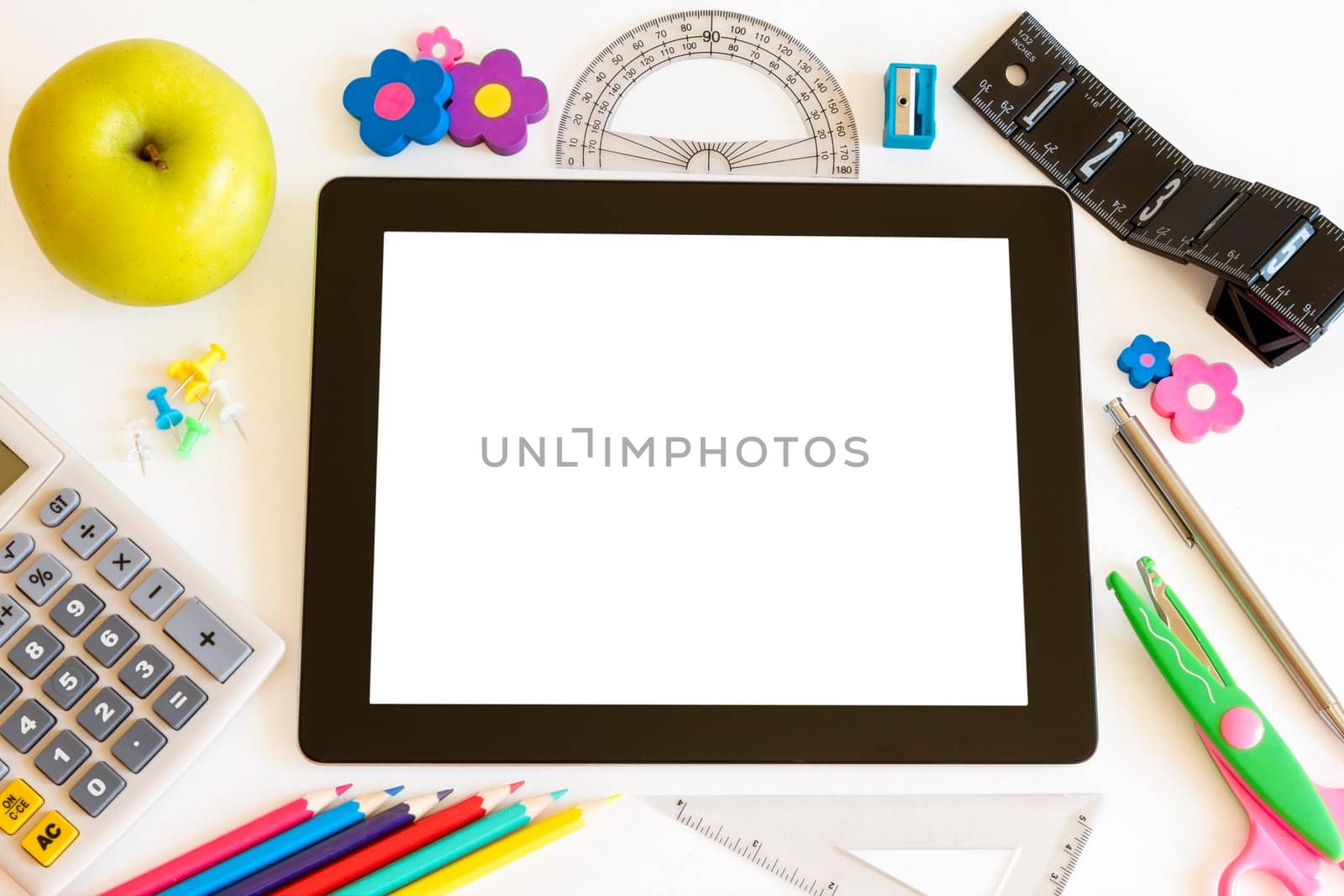 Tablet PC with school accesories on white background