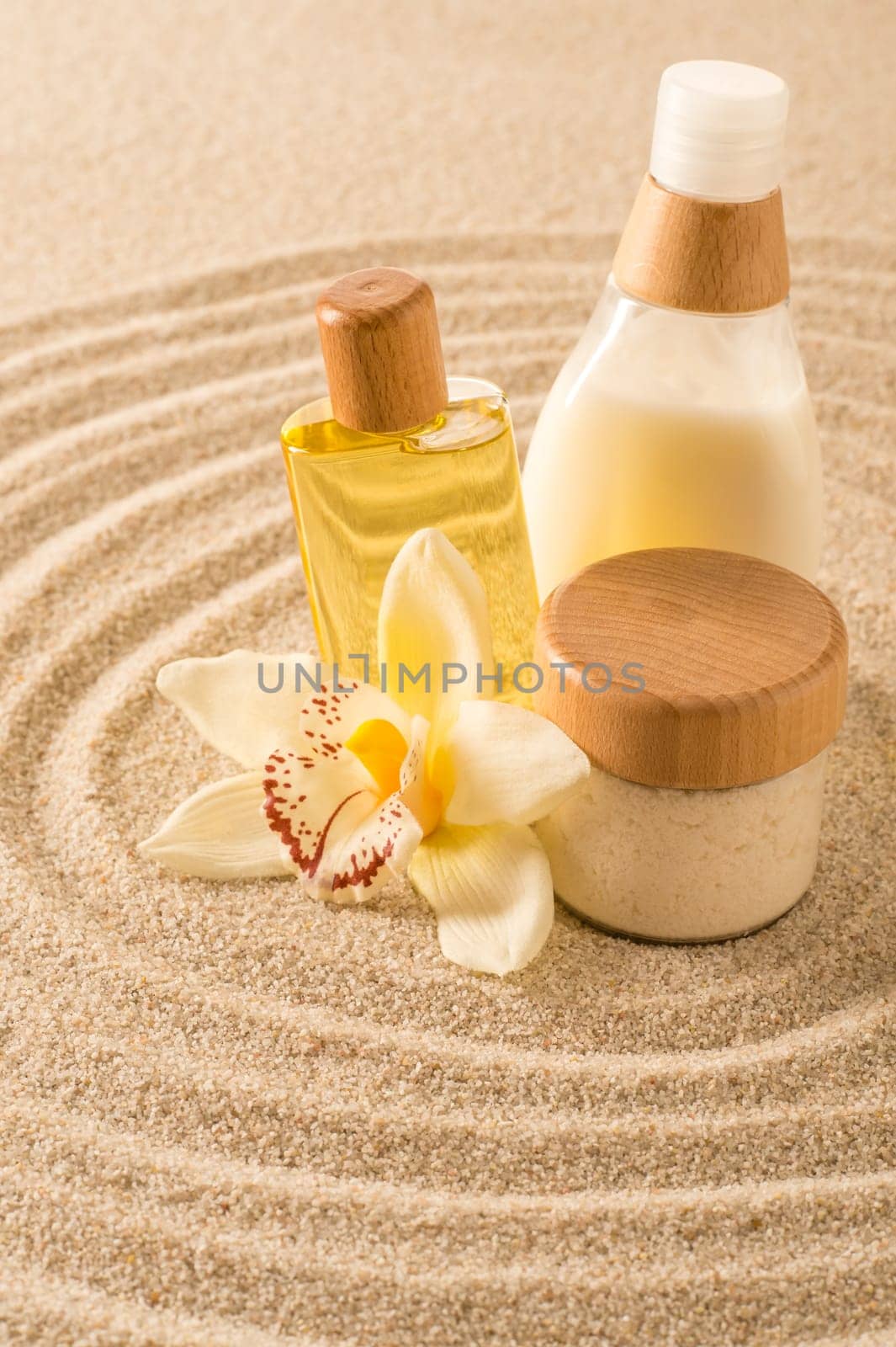 Spa body product on sand orchid flower beauty treatment