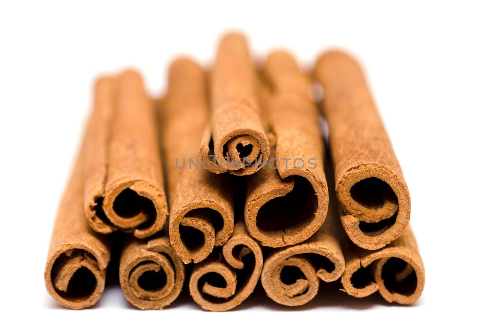 Extreme close-up of cinnamon rods on white background