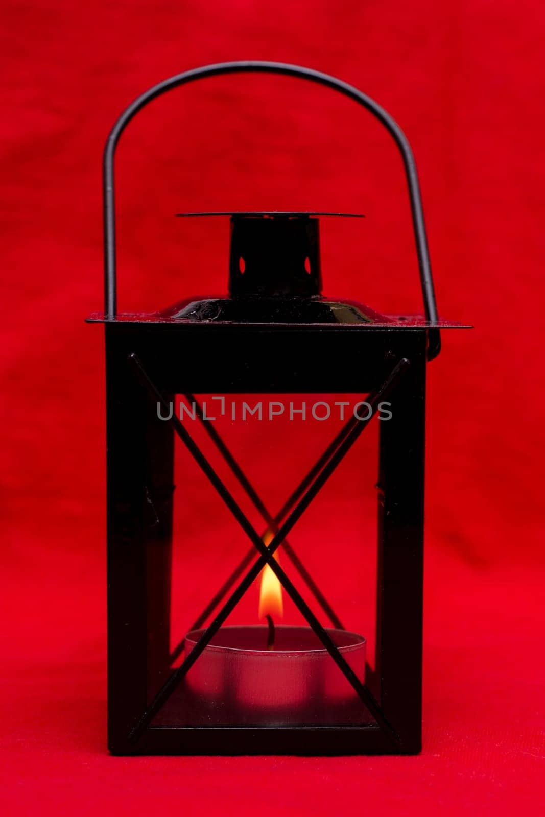 Black lantern with burning candle