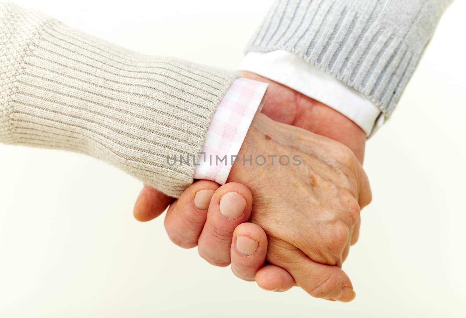Seniors holding hands indicating their commitment to each other