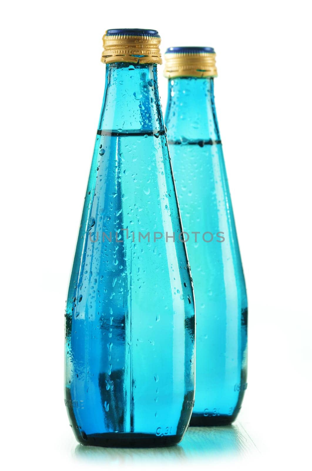 Glass bottle of mineral water isolated on white