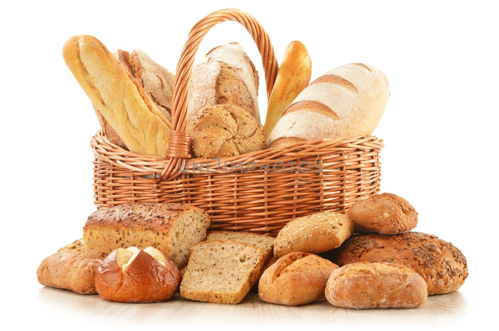 Composition with bread and rolls in wicker basket isolated on white