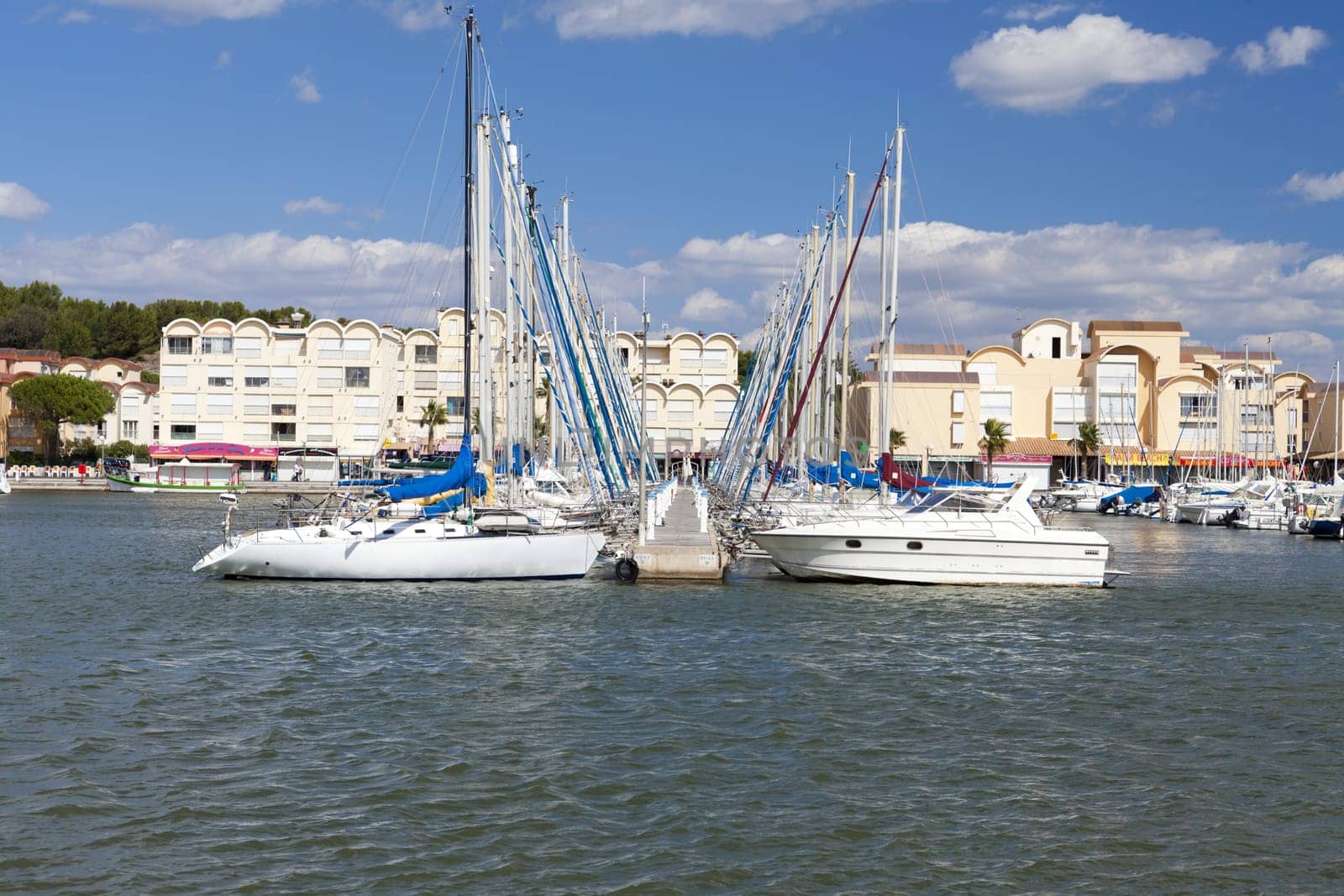 View of a jetty with numerous ships in the port of Gruissan