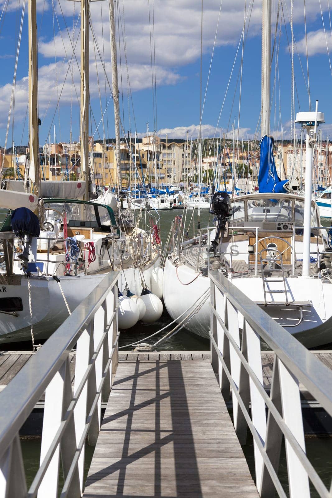 Wide angle view of a jetty with sailing yachts in the port of Gruissan in the south of France