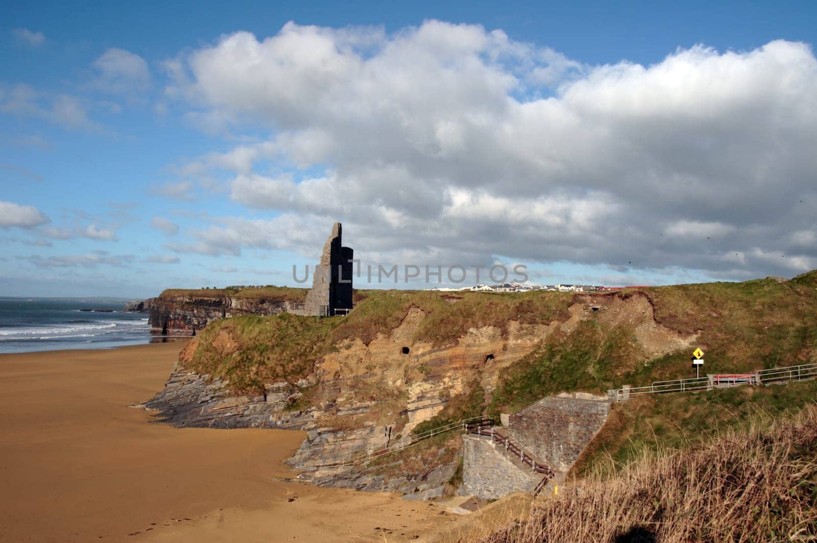 ballybunion castle on the cliffs in the west coast of ireland above a beautiful beach