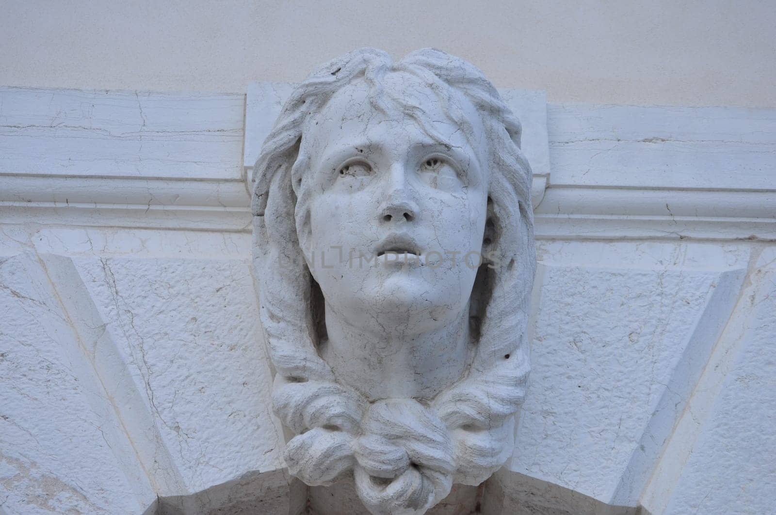 Detail of an ancient Venetian mask in the city of Venice (Venezia) in Italy