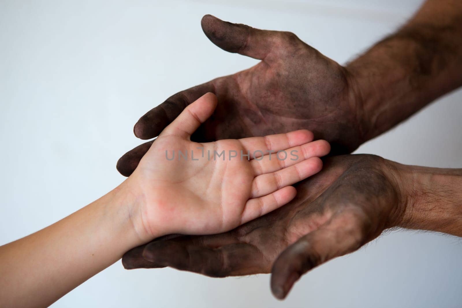 black dirty man hands holding kid clean hand concept