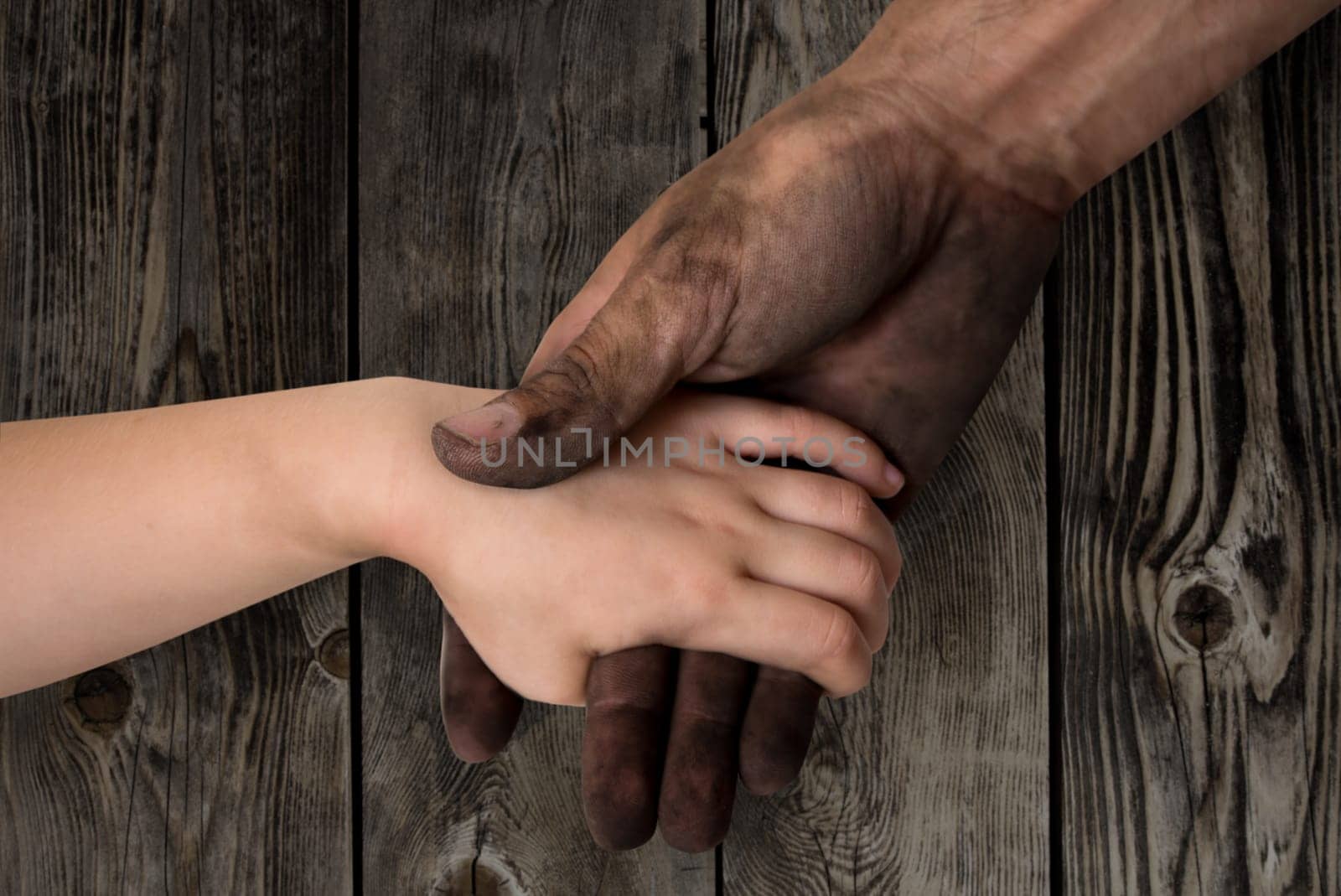 black dirty man hands holding kid clean hand concept