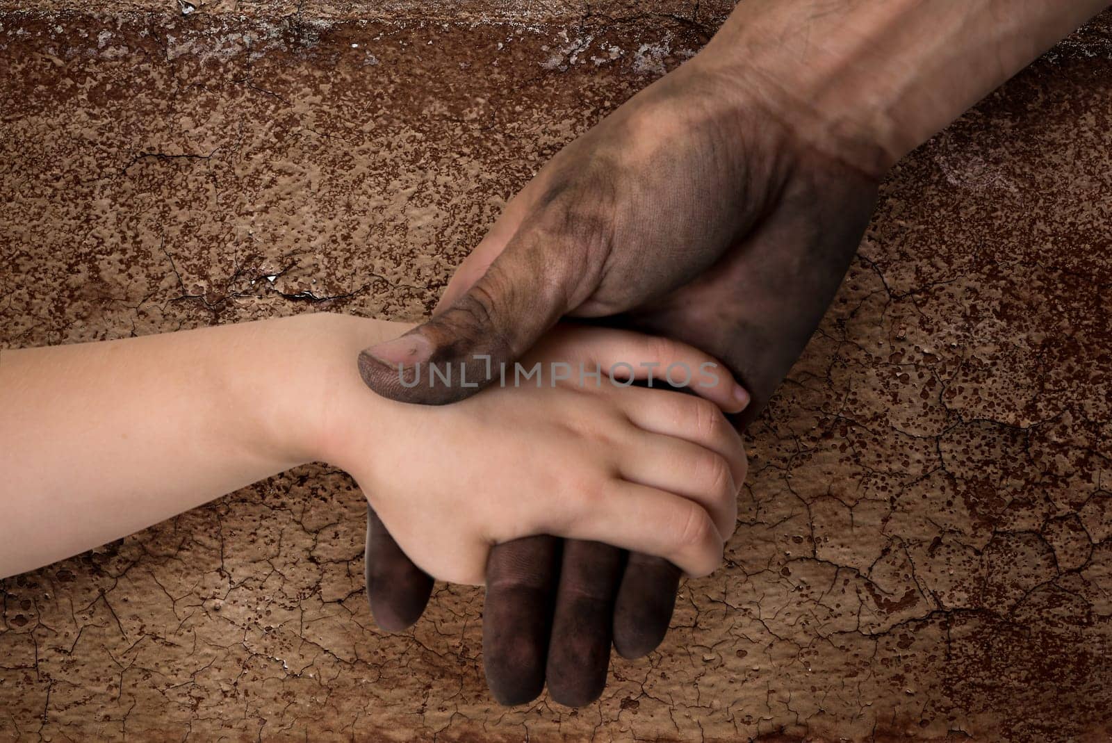 black dirty man hands holding kid clean hand concept
