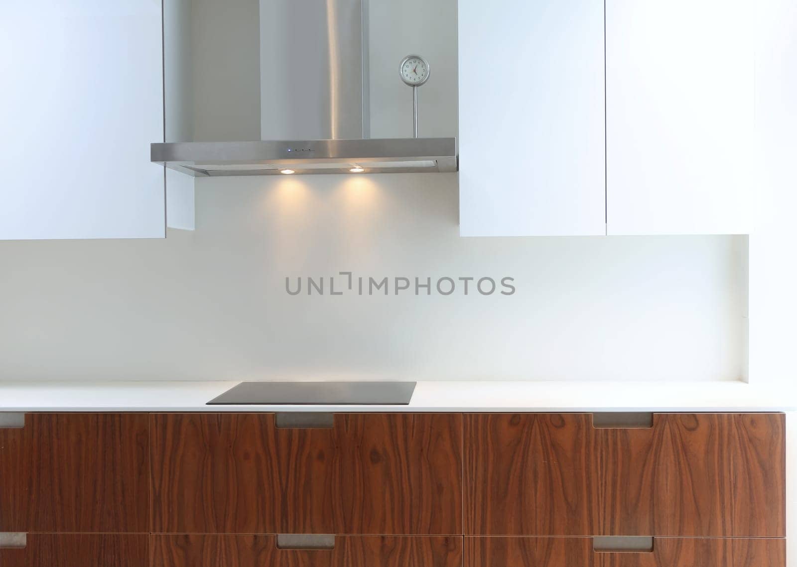 Actual modern kitchen in white and walnut wood interior house