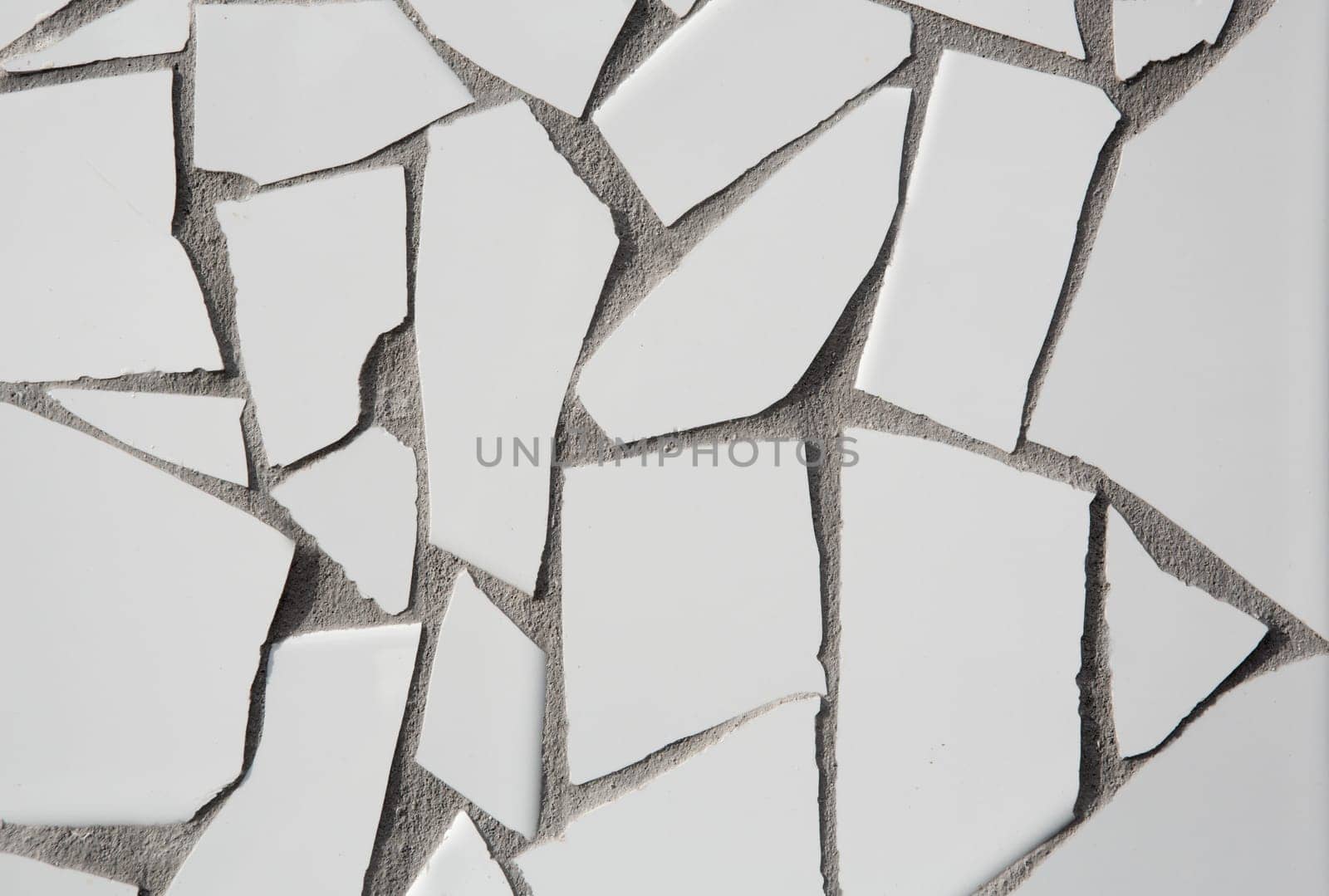 trencadis mosaic of white broken tiles in Mediterranean with cement gray joints