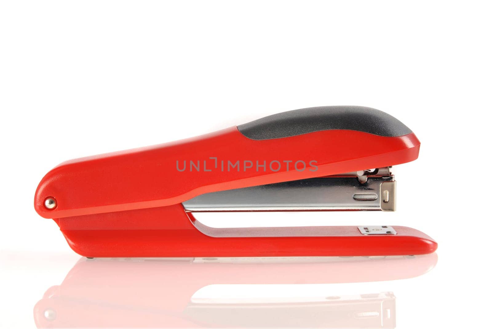 A red and black stapler isolated with reflection on white background.  Included clipping path, so you can easily cut it out and place over the top of a design.