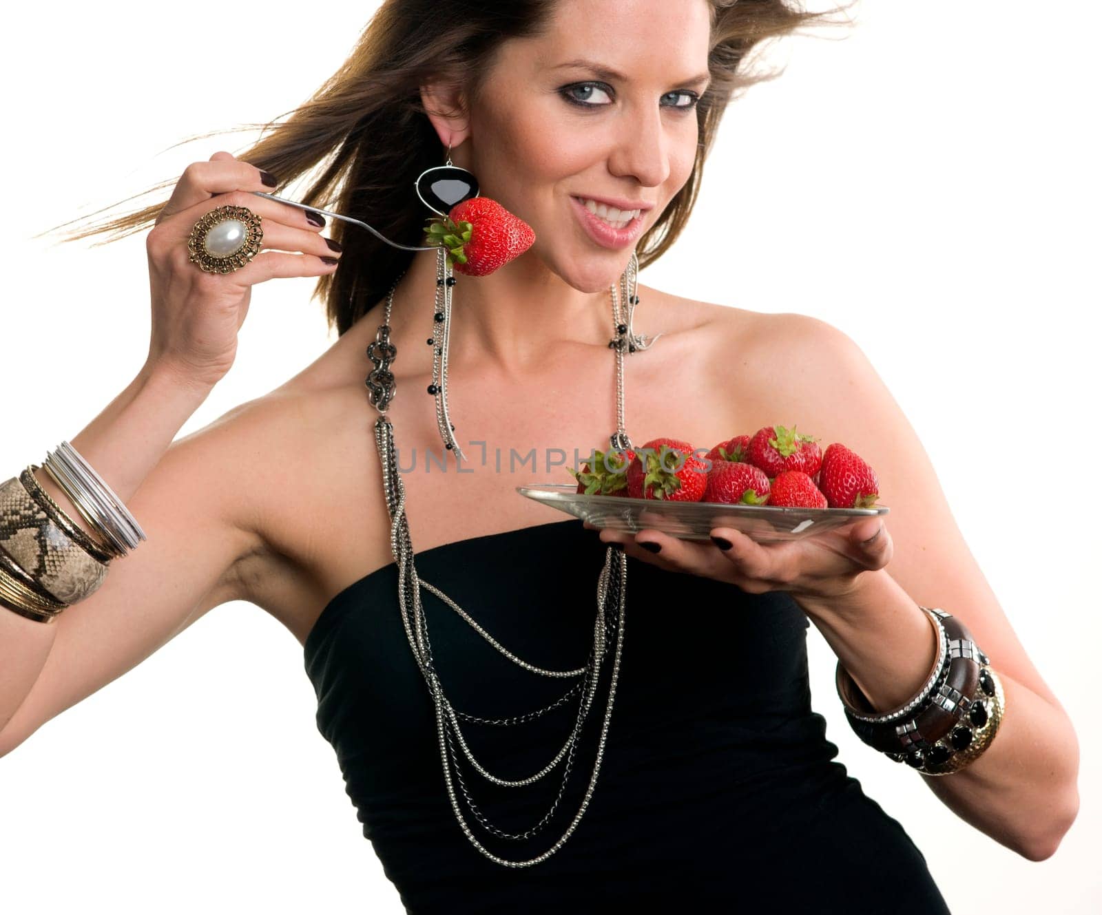Woman eats Strawberry with a fork