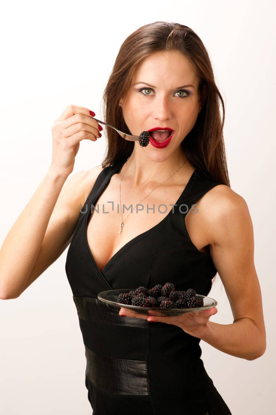 Woman eats Blackberries on a Fork