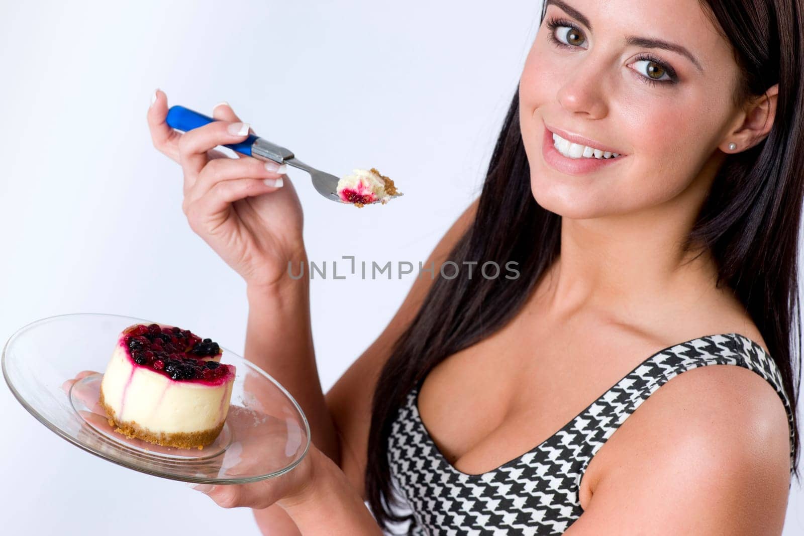 Woman eats Cheesecake with a fork