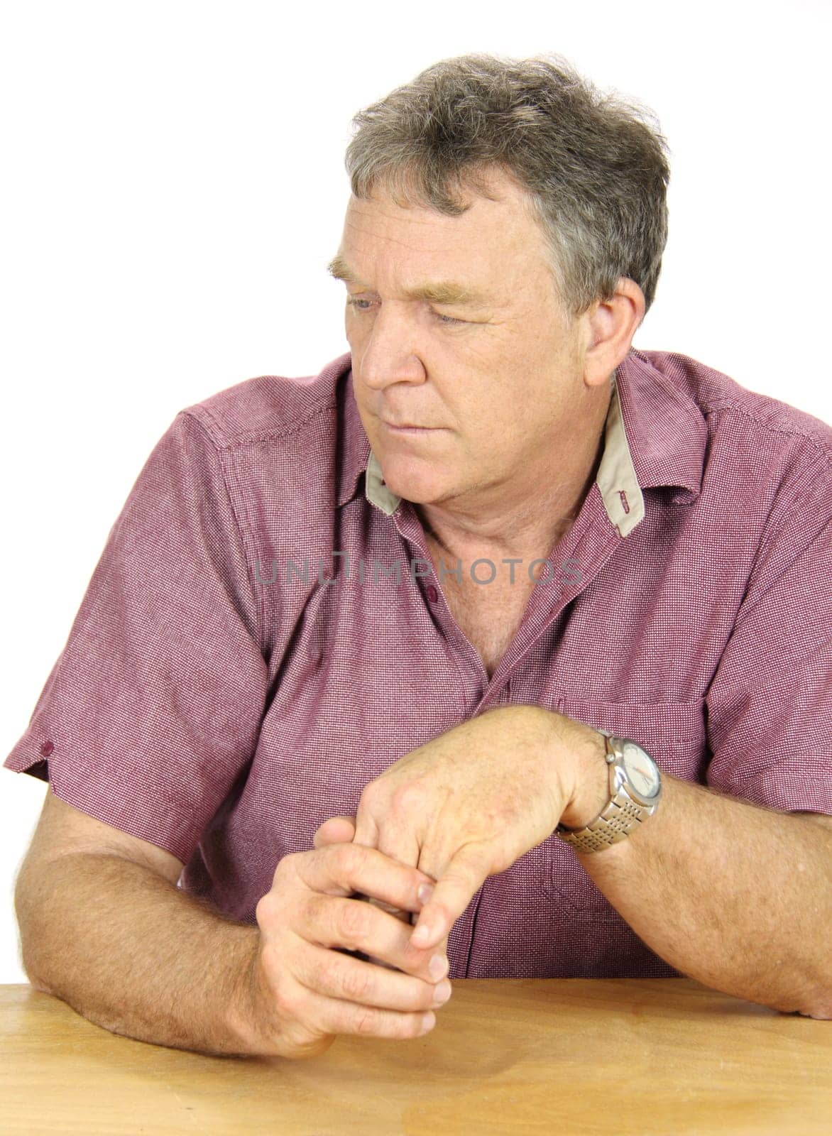 Dejected and depressed middle aged man looks away from camera.