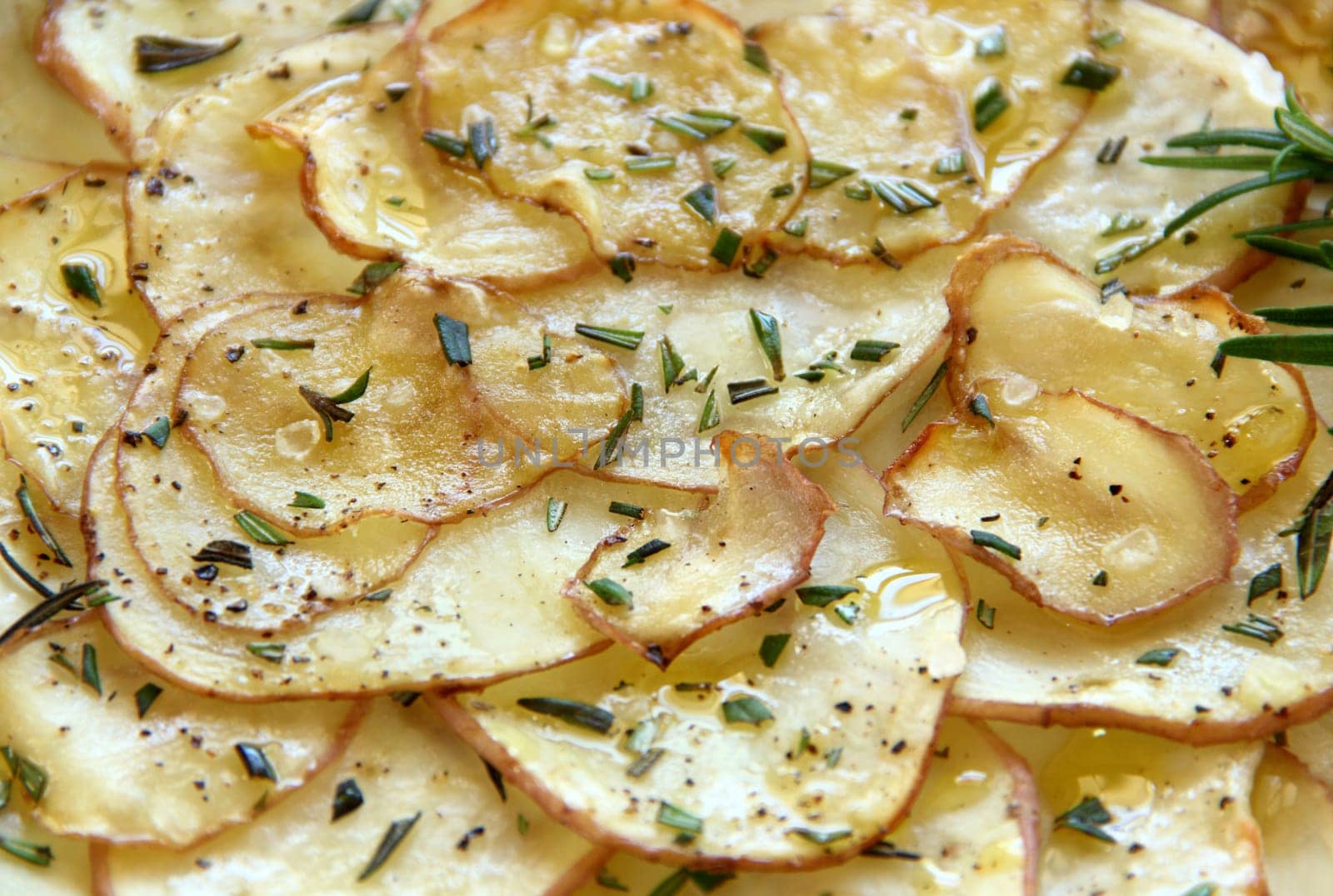 Delicious crispy baked potato chips with rosemary ready to serve.