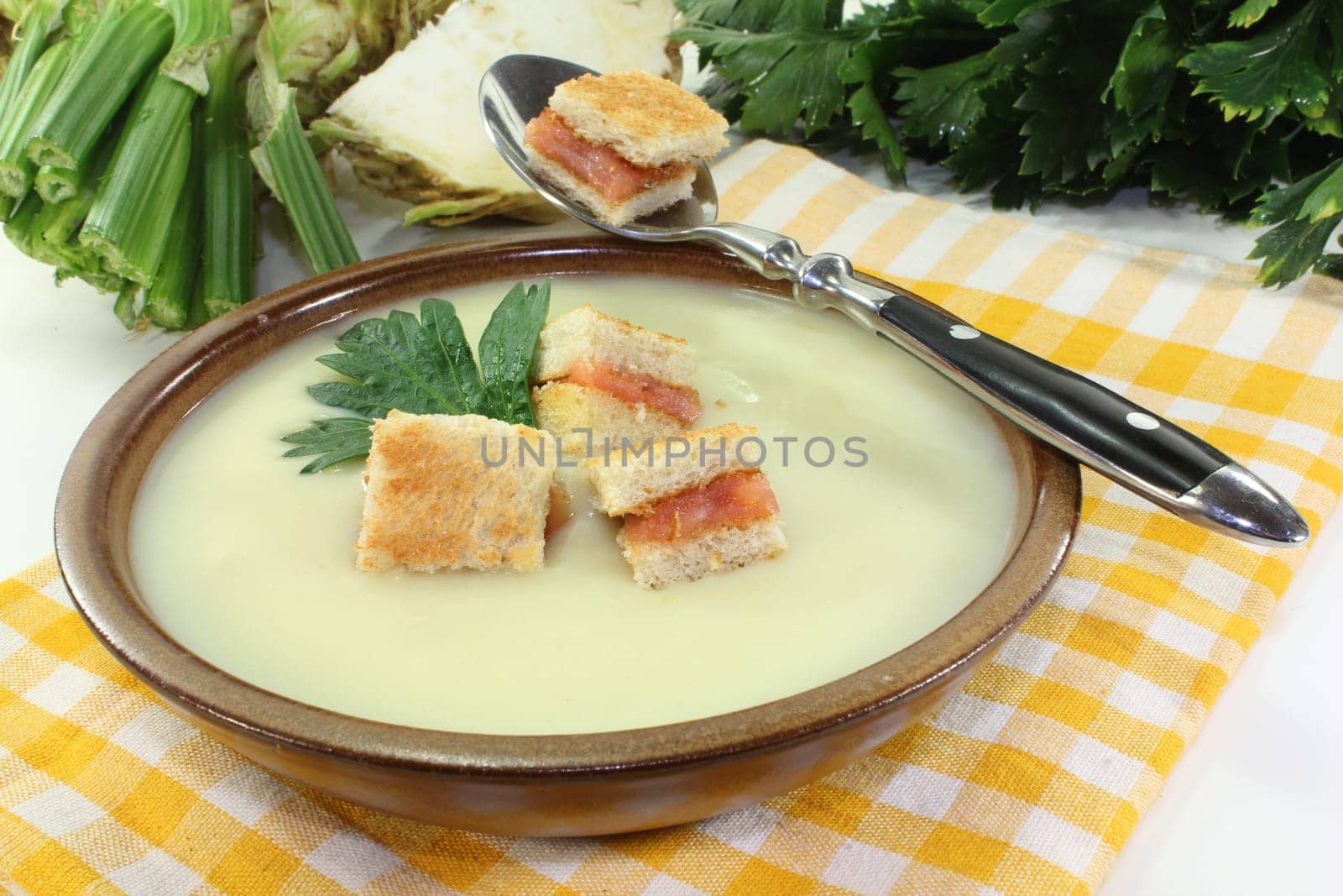 a bowl of cream of celery soup with salmon croutons