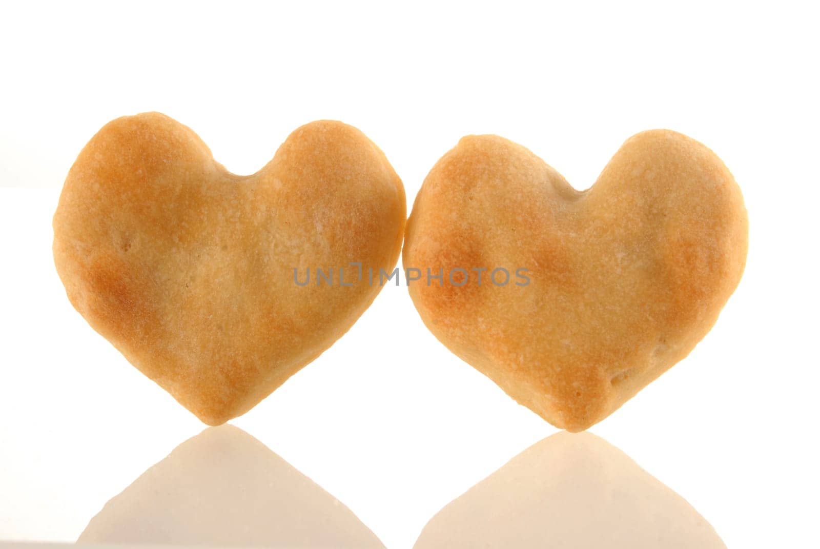 Two heart cookies isolated and its reflection on white background.  Included clipping path, so you can easily cut it out and place over the top of a design.