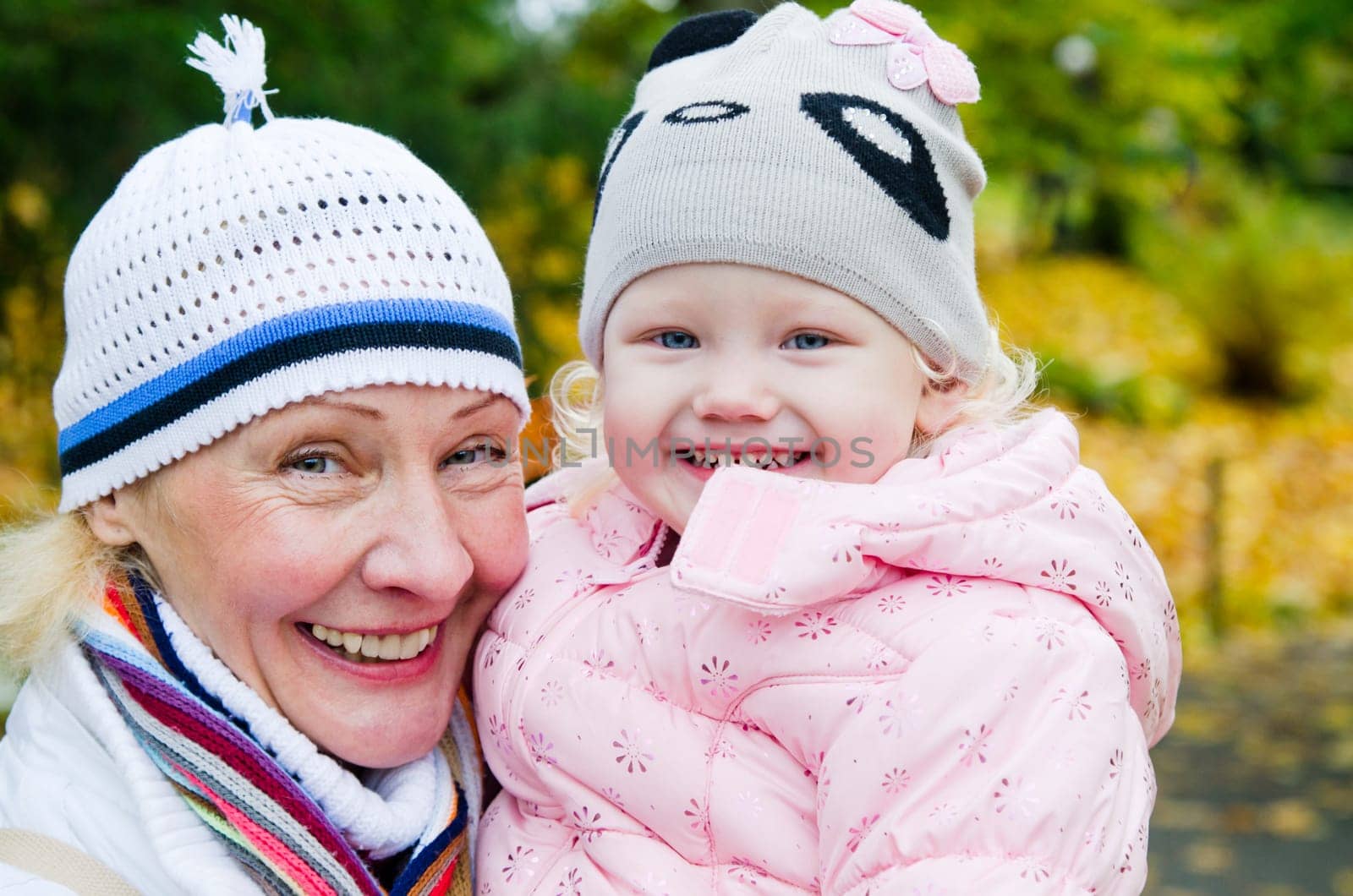 grandmother with the grand daughter in autumn park