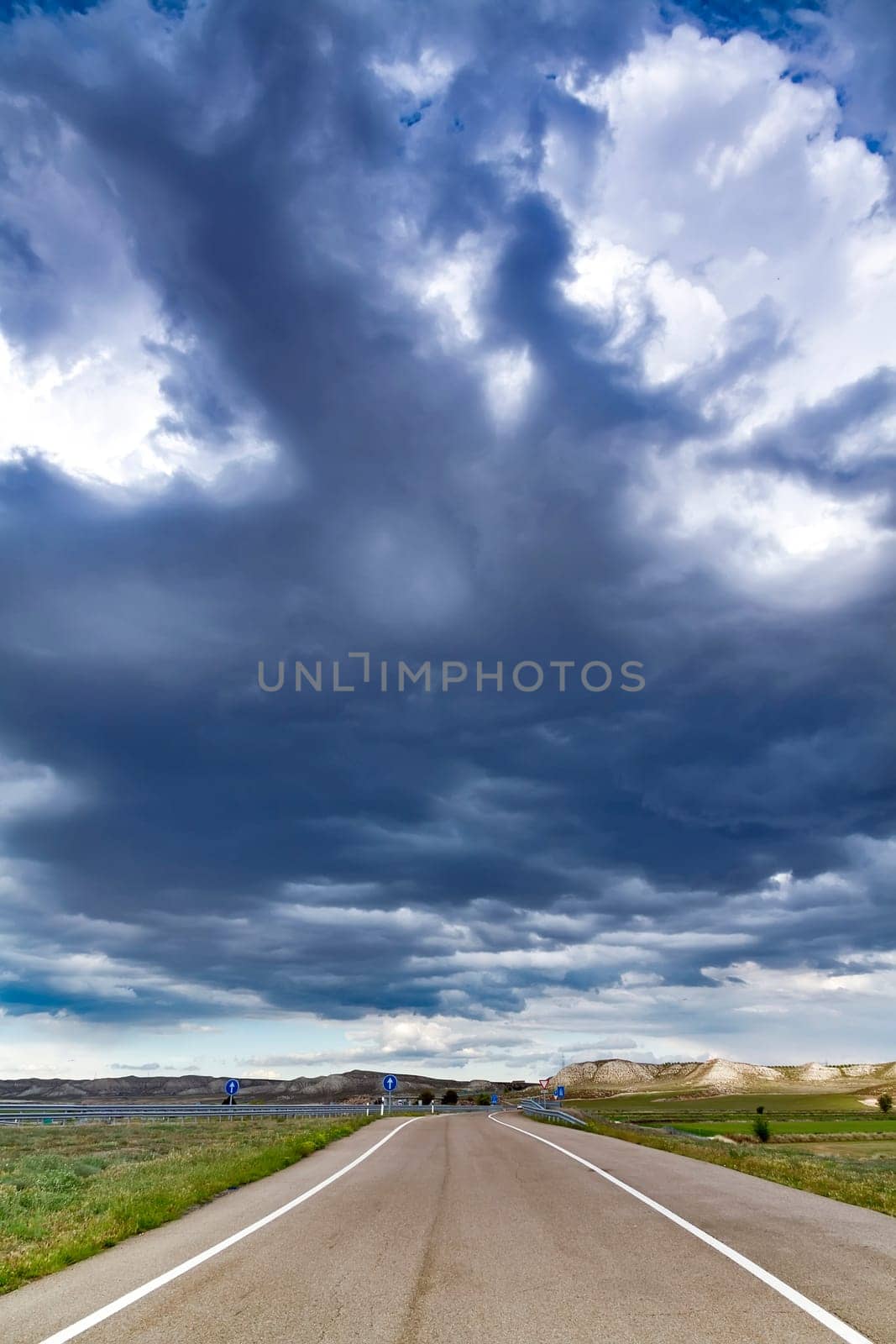 Asphalt road and blue sky with clouds