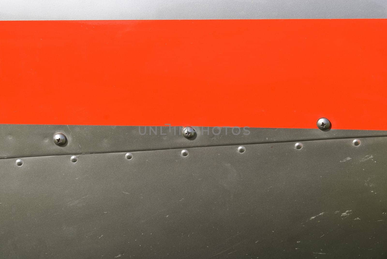 Red and silvel metal texture with rivets and screws. Useful as background for design works.