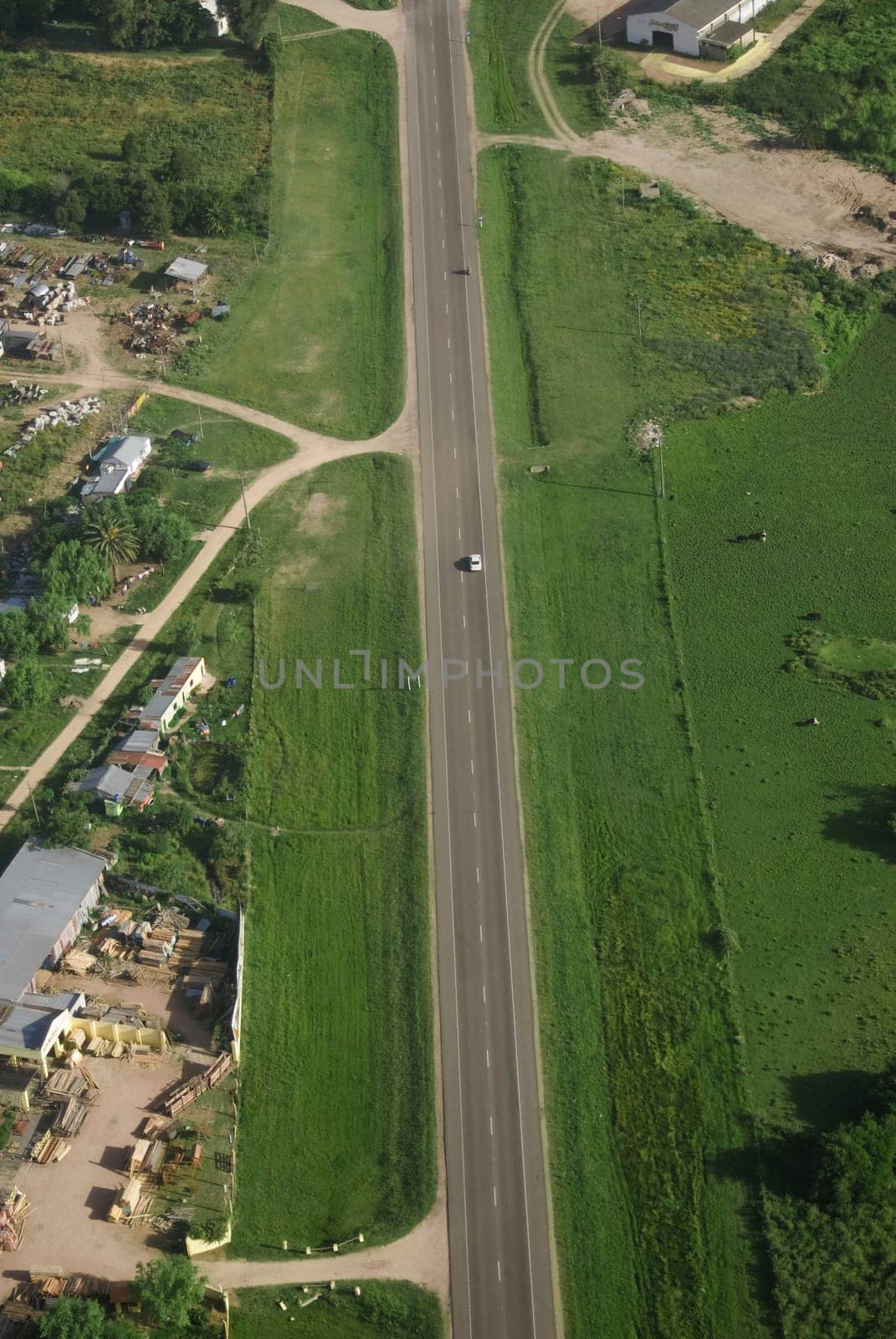 Aerial view of road in green fields in Uruguay.
