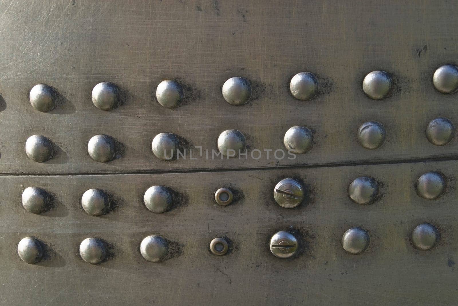 Silvel metal texture with rivets and screws. Useful as background for design works.