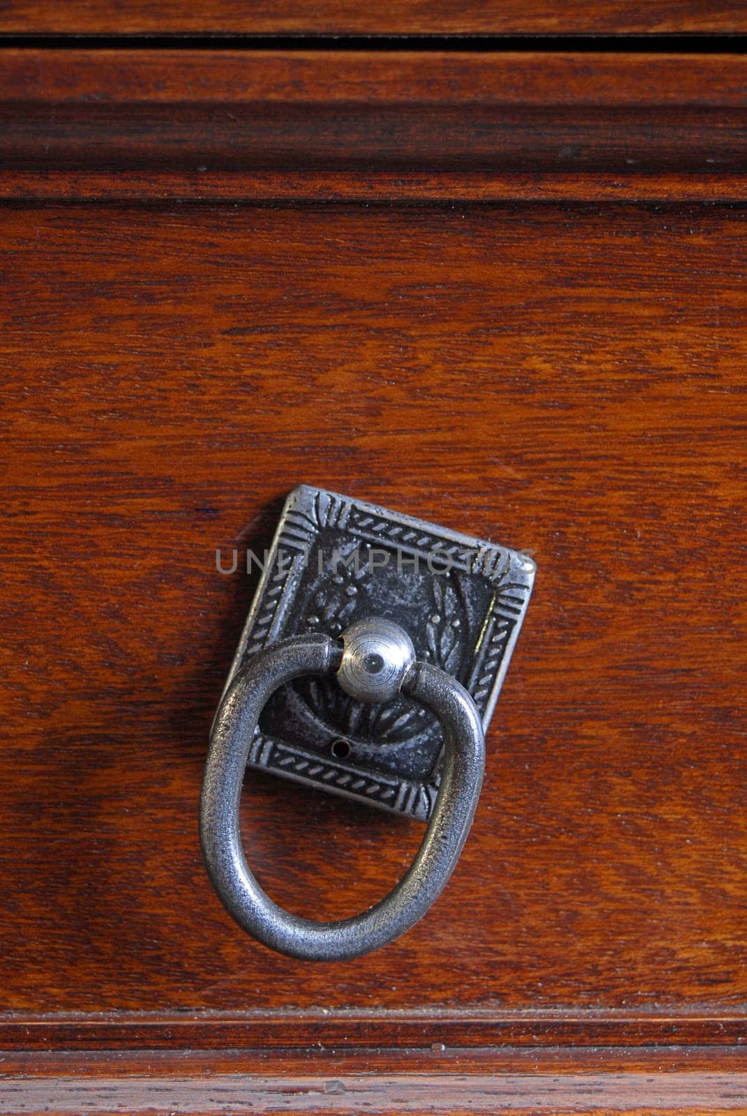 Drawer pull on a wooden texture background