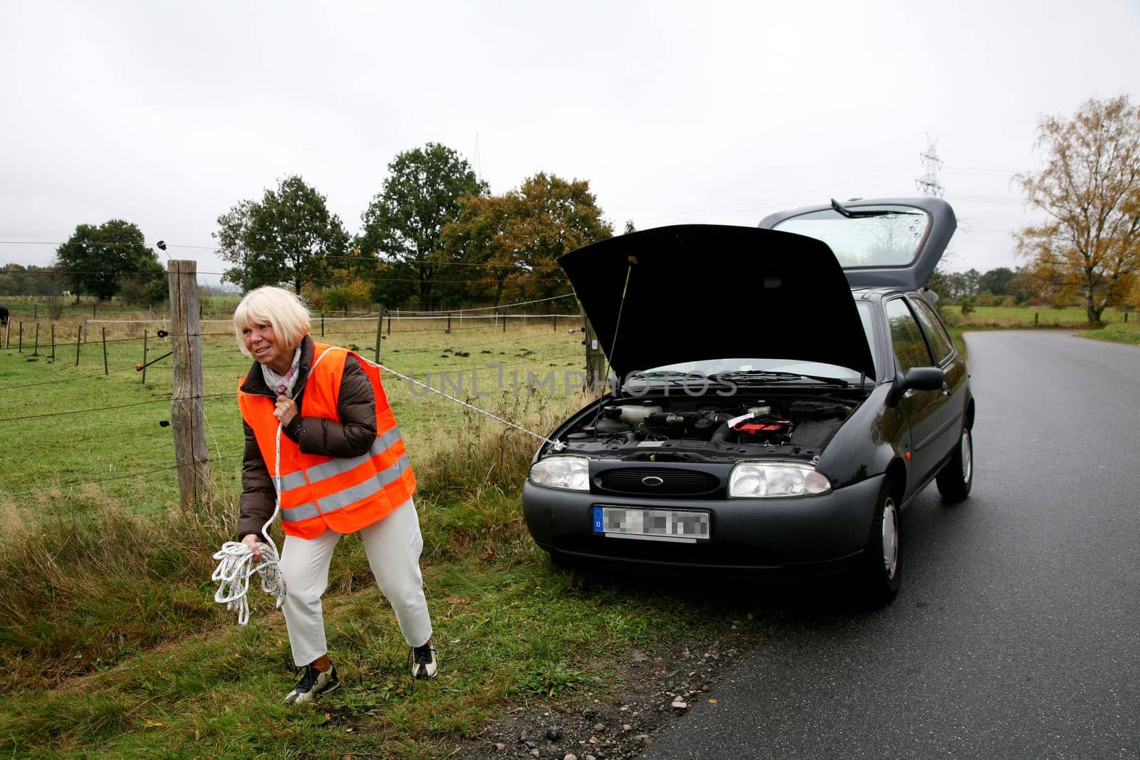 Senior citizen tows car