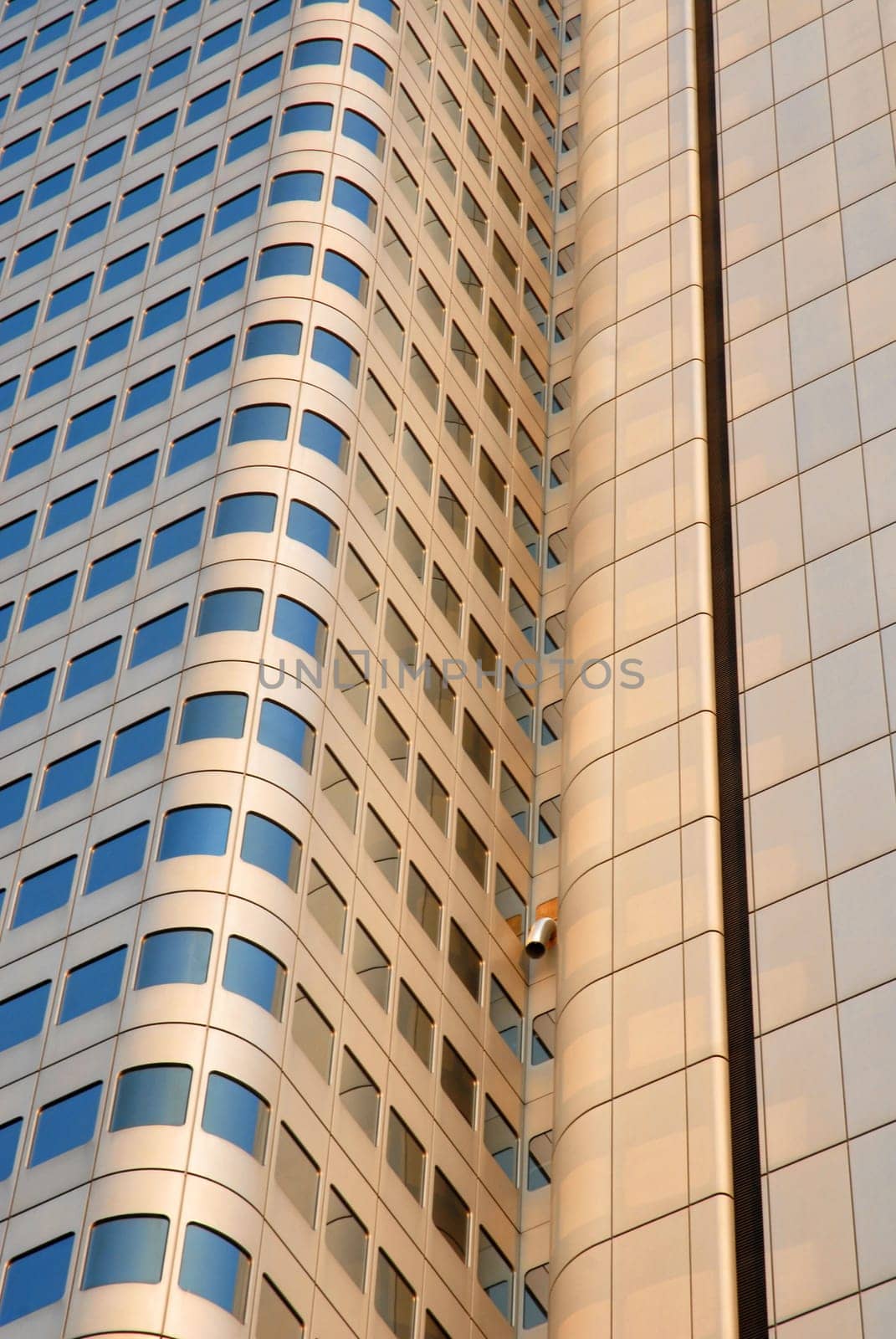 Golden skyscraper reflecting a blue sky