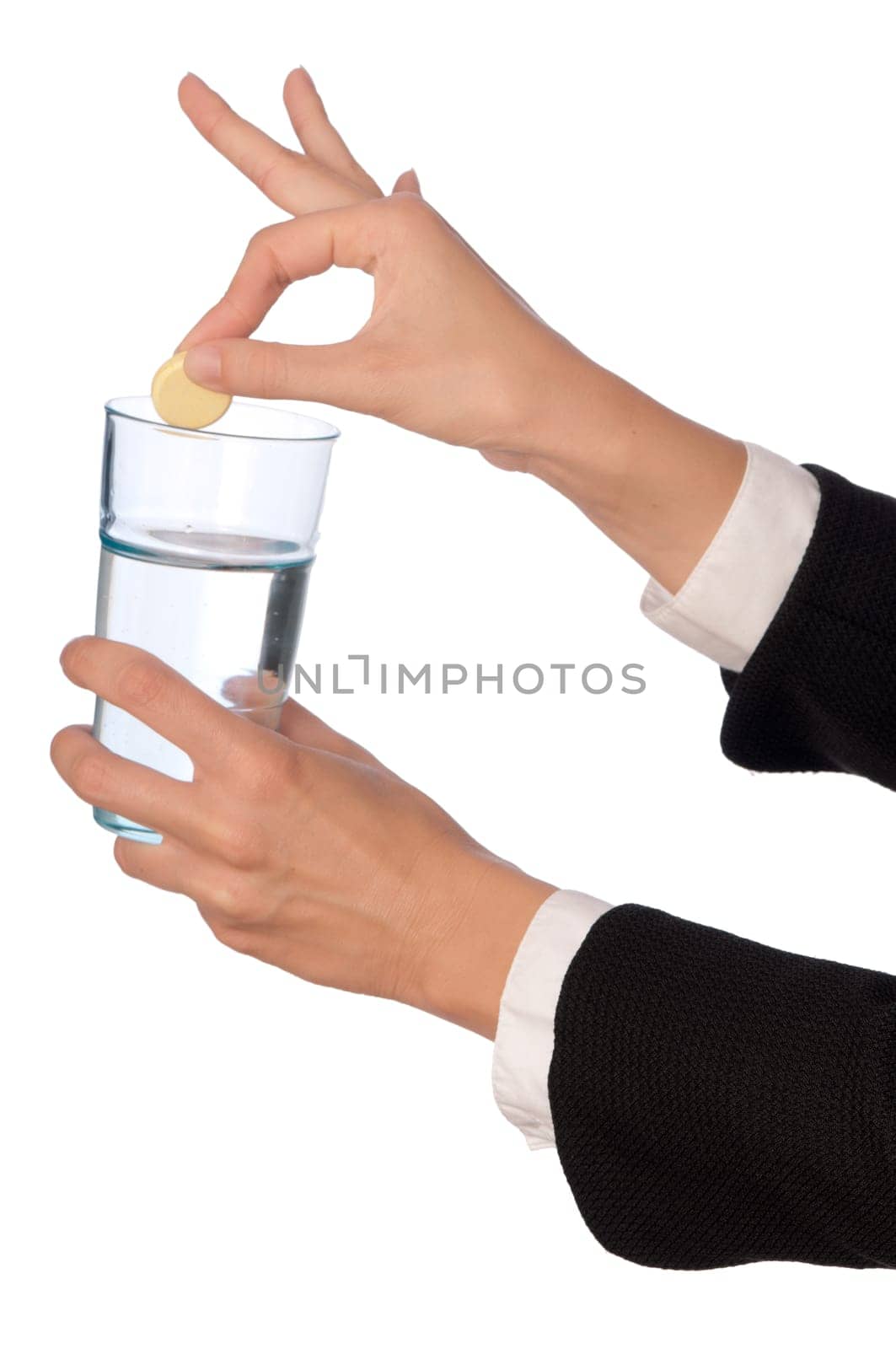 Businesswoman throws a pill from headache to the glass with water