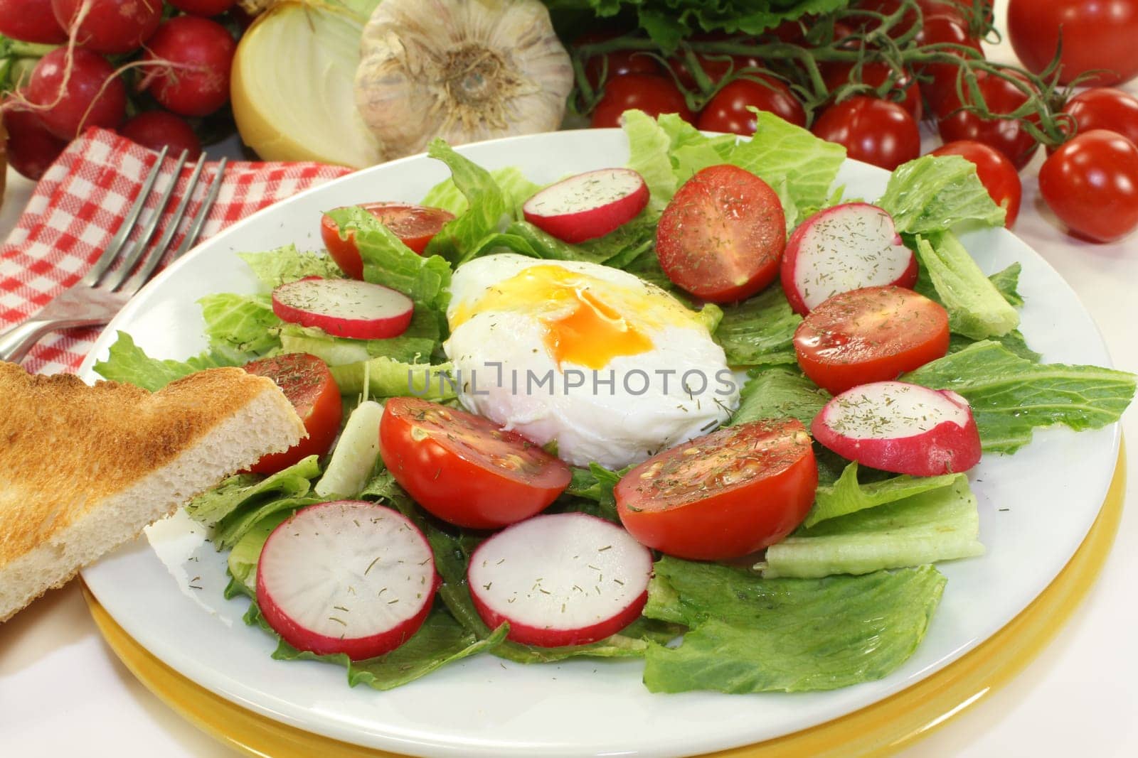 mixed colorful salad with poached egg
