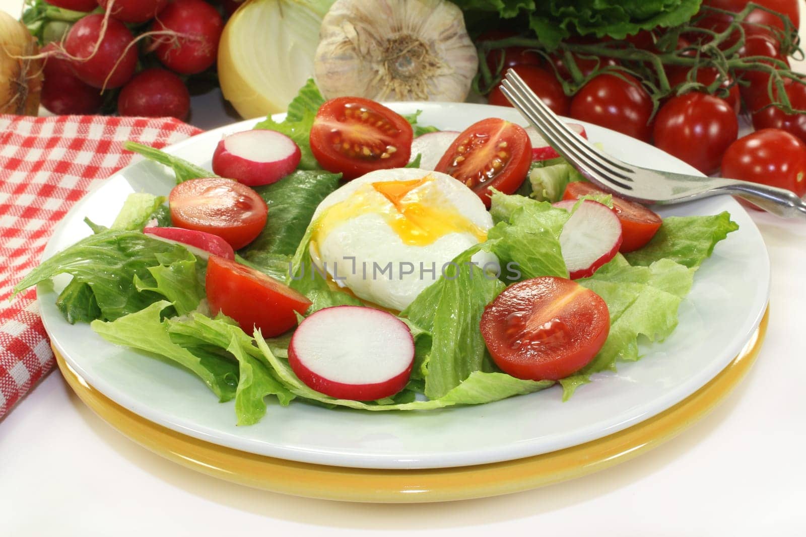 mixed colorful salad with poached egg