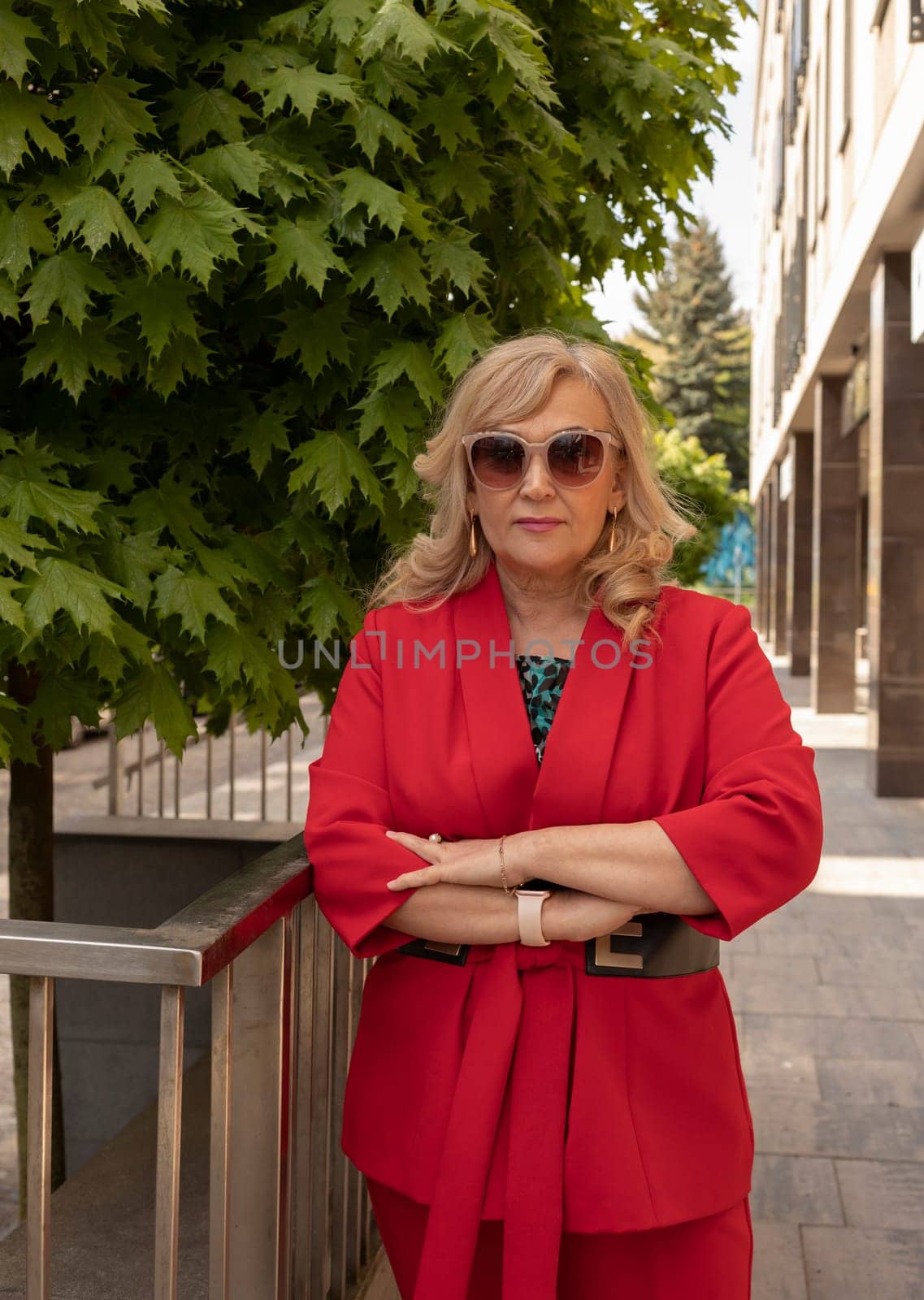 Portrait Posing Business Lady, Mature Sexagenarian Woman Outdoor in Summer Time, City, Stylish Confident Senior Female in her 60s Wears Sunglasses. Boss or Manager. Vertical Plane. High quality photo