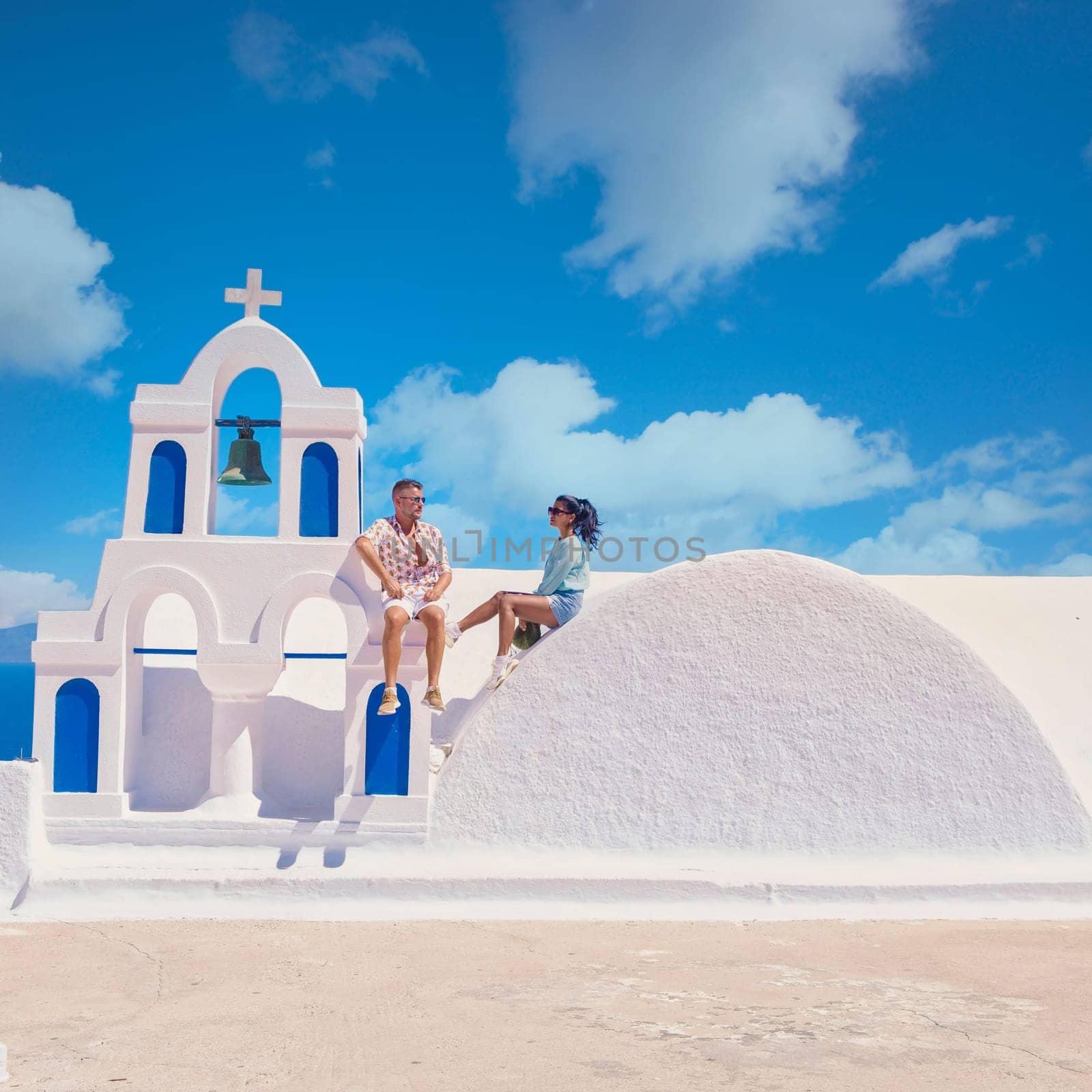 couple men and woman on vacation Santorini Greece. young couple on vacation in Greece by fokkebok